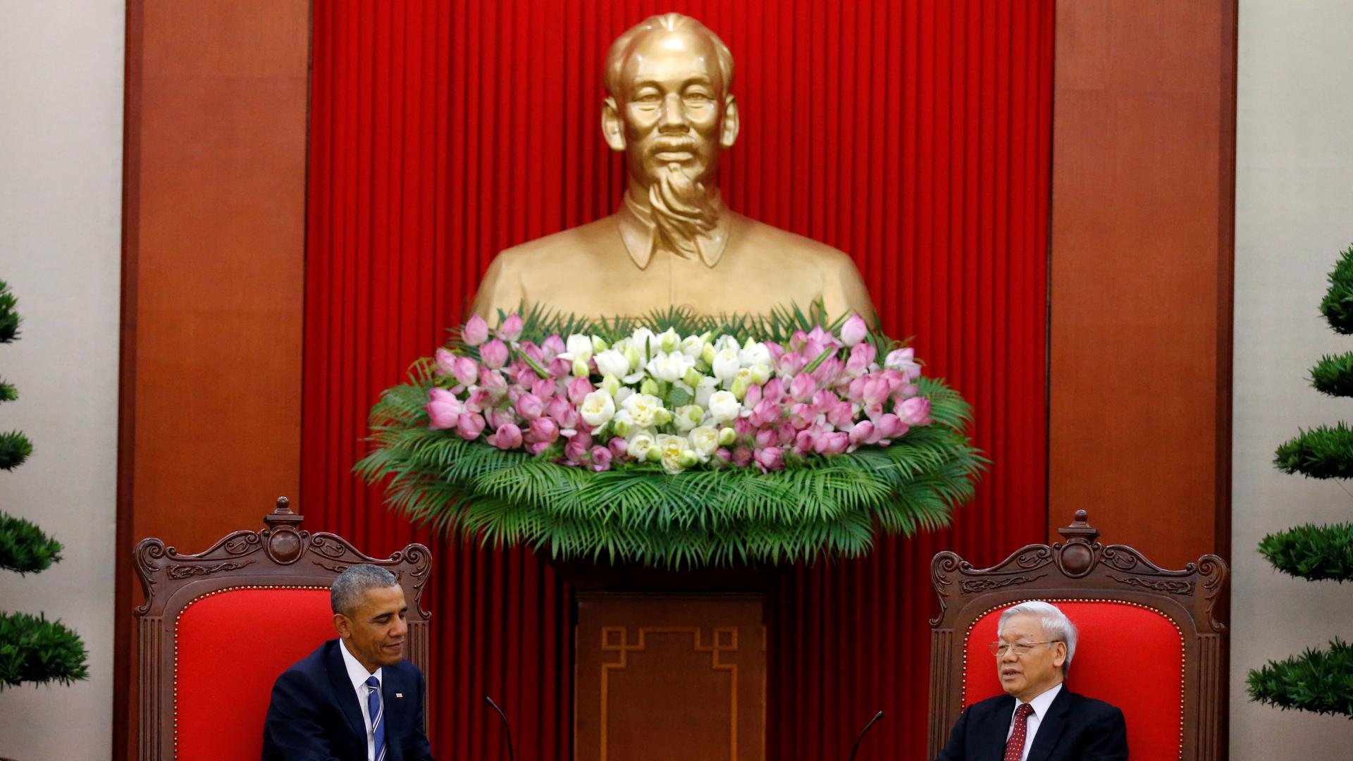 President Obama, in Hanoi, meets with Vietnam's Communist Party chief under a statue of Ho Chi Minh