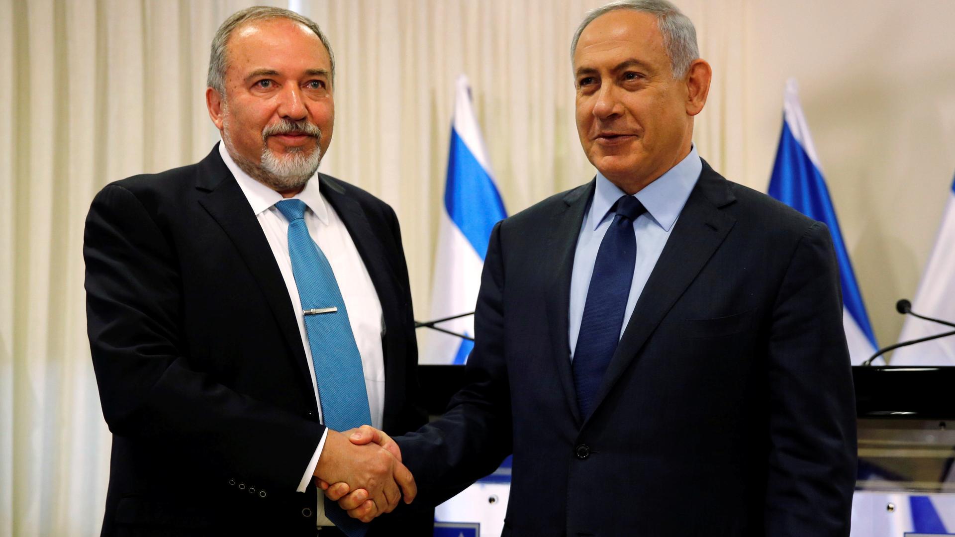 Avigdor Lieberman (L) and Israeli Prime Minister, Benjamin Netanyahu, after agreeing a new coalition deal last week, which gave Lieberman the Defense Ministry