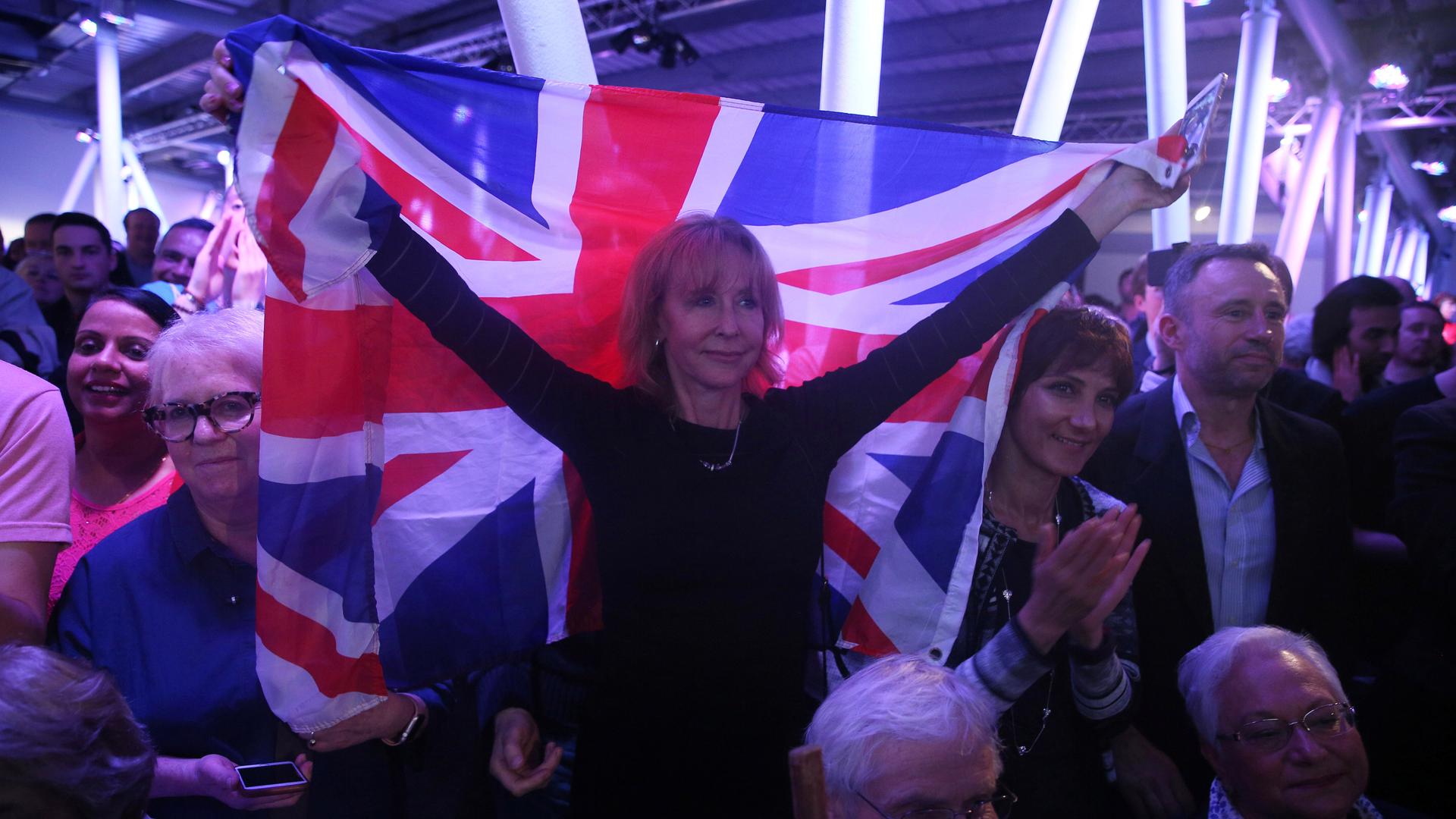 A Brexit supporter holds a Union Flag at a ‘Vote Leave’ rally in London