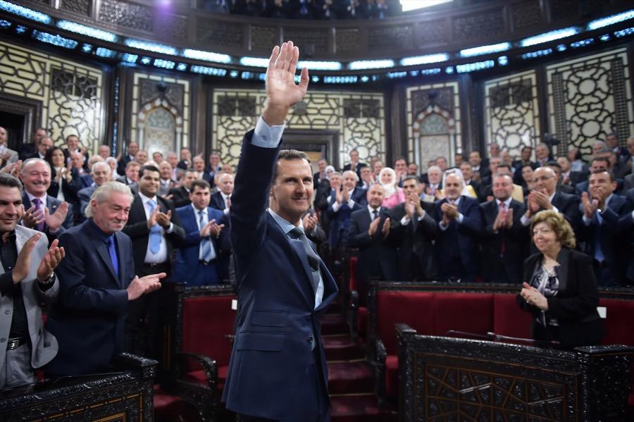 Syria's President Bashar al-Assad gestures while parliament members clap in Damascus, Syria on June 7, 2016.