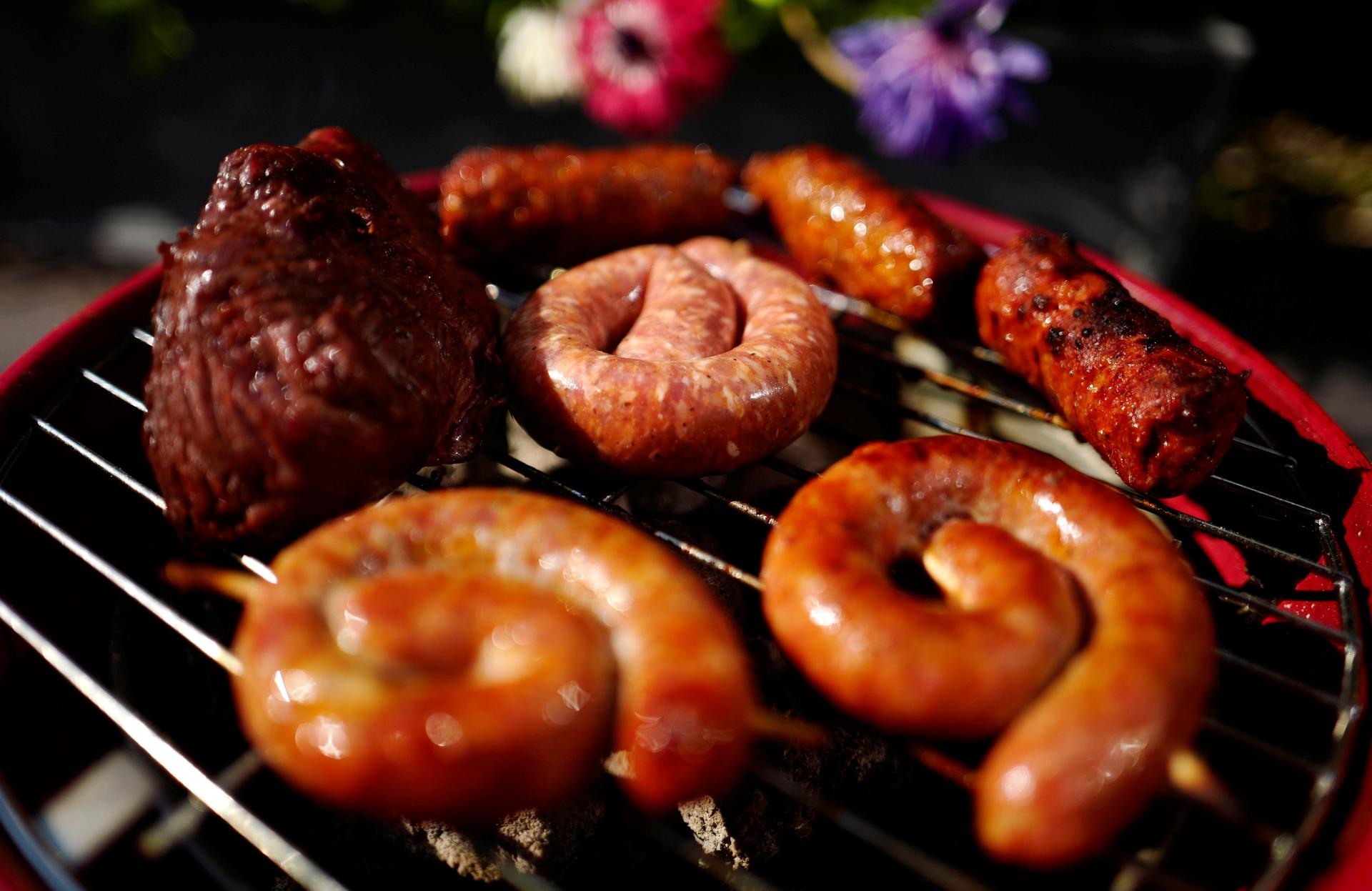 Sausages and meat grill on a charcoal barbecue in a garden in Hanau near Frankfurt, Germany, June 7, 2016.