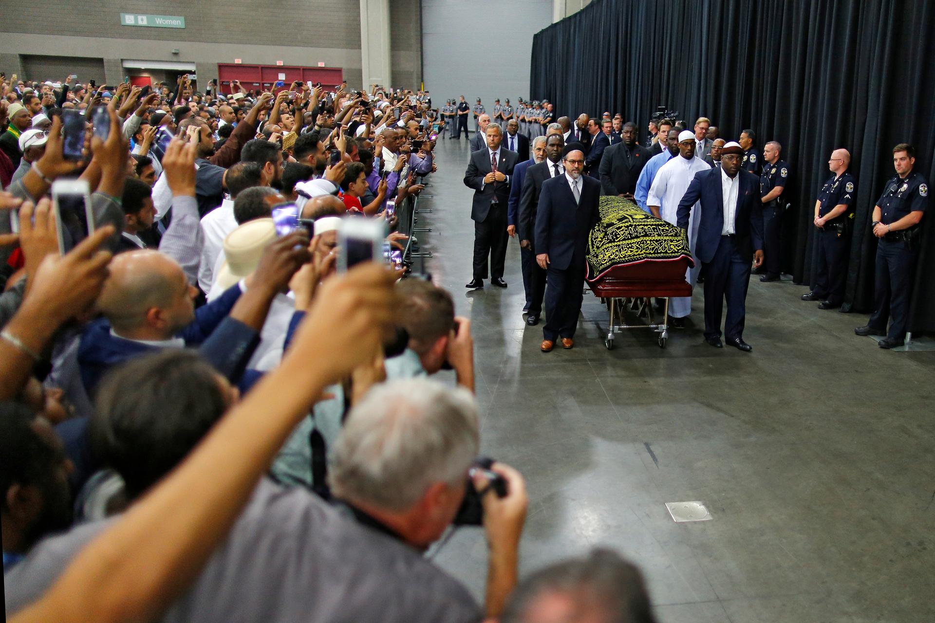 Worshipers and well-wishers take photographs as the casket with the body of the late boxing champion Muhammad Ali is brought for his jenazah, an Islamic funeral prayer, in Louisville, Kentucky, U.S. on June 9, 2016.
