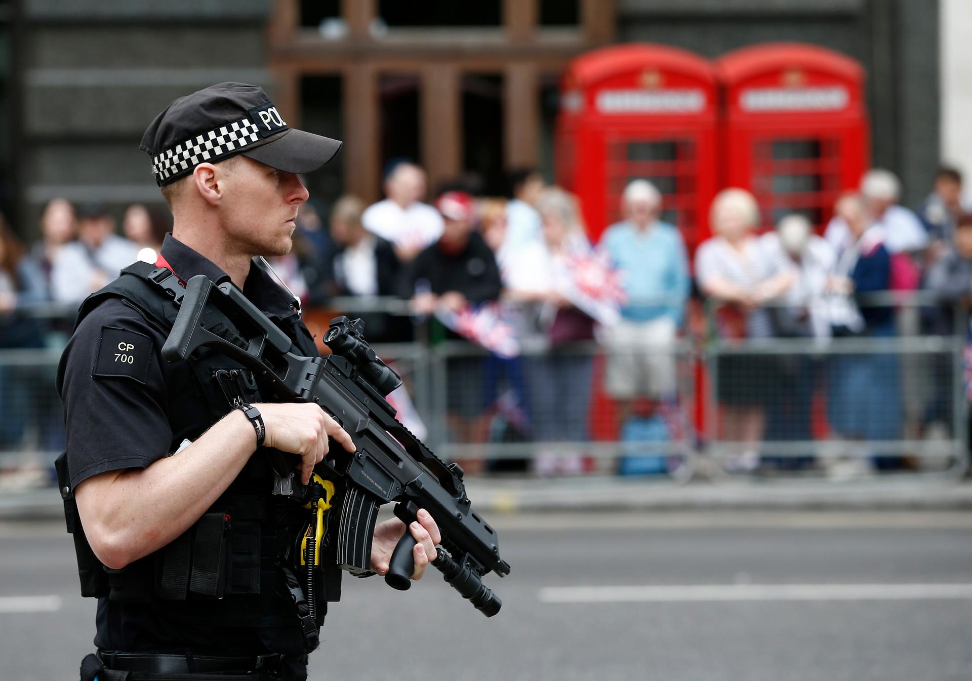An armed police officer patrols ahead of the arrival of members of Britain's royal family to a service of thanksgiving for Queen Elizabeth's 90th birthday at St Paul's cathedral in London, Britain, June 10, 2016.