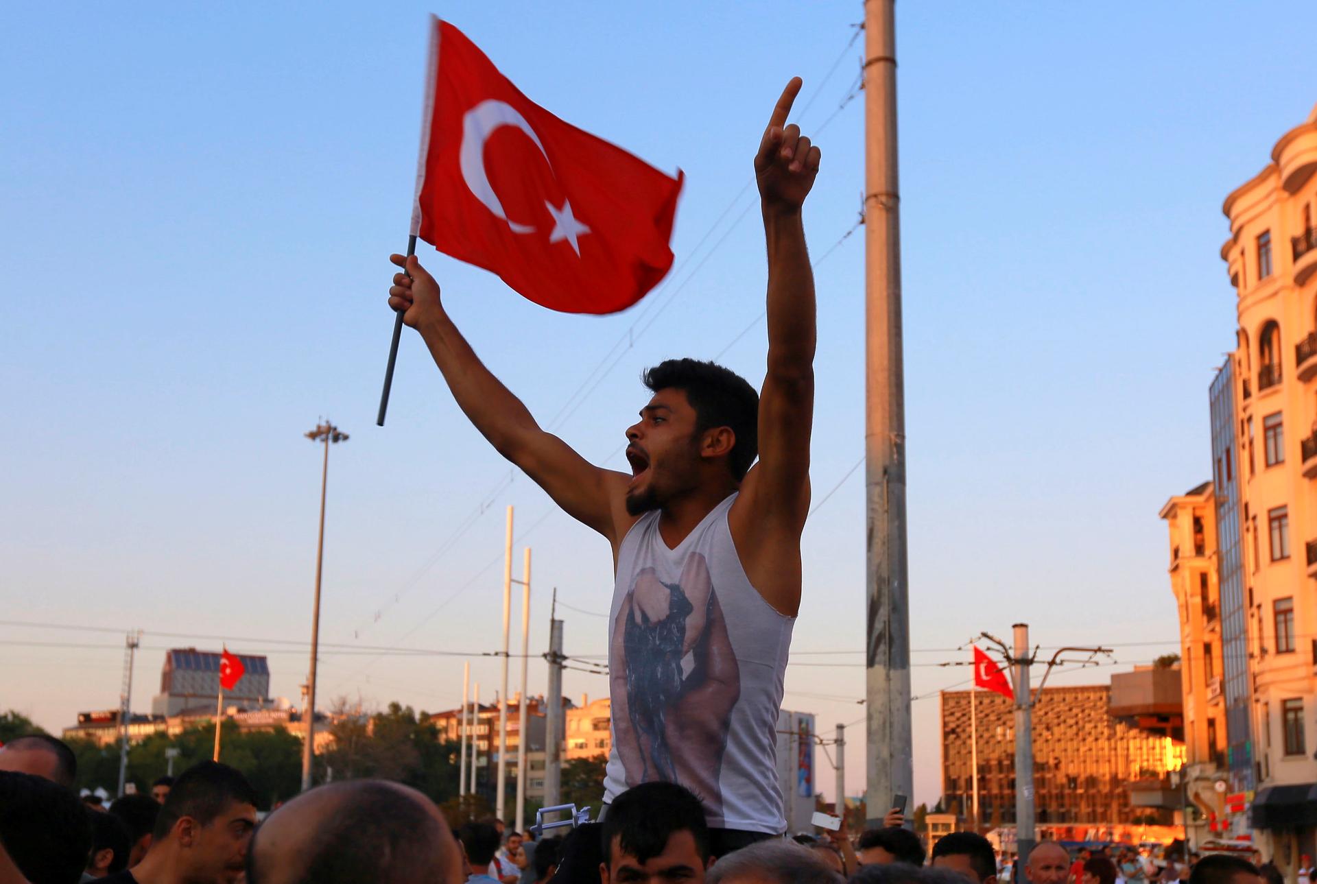 A man waves a Turkish flag at Taksim Square in Istanbul on July 16 after a coup attempt.