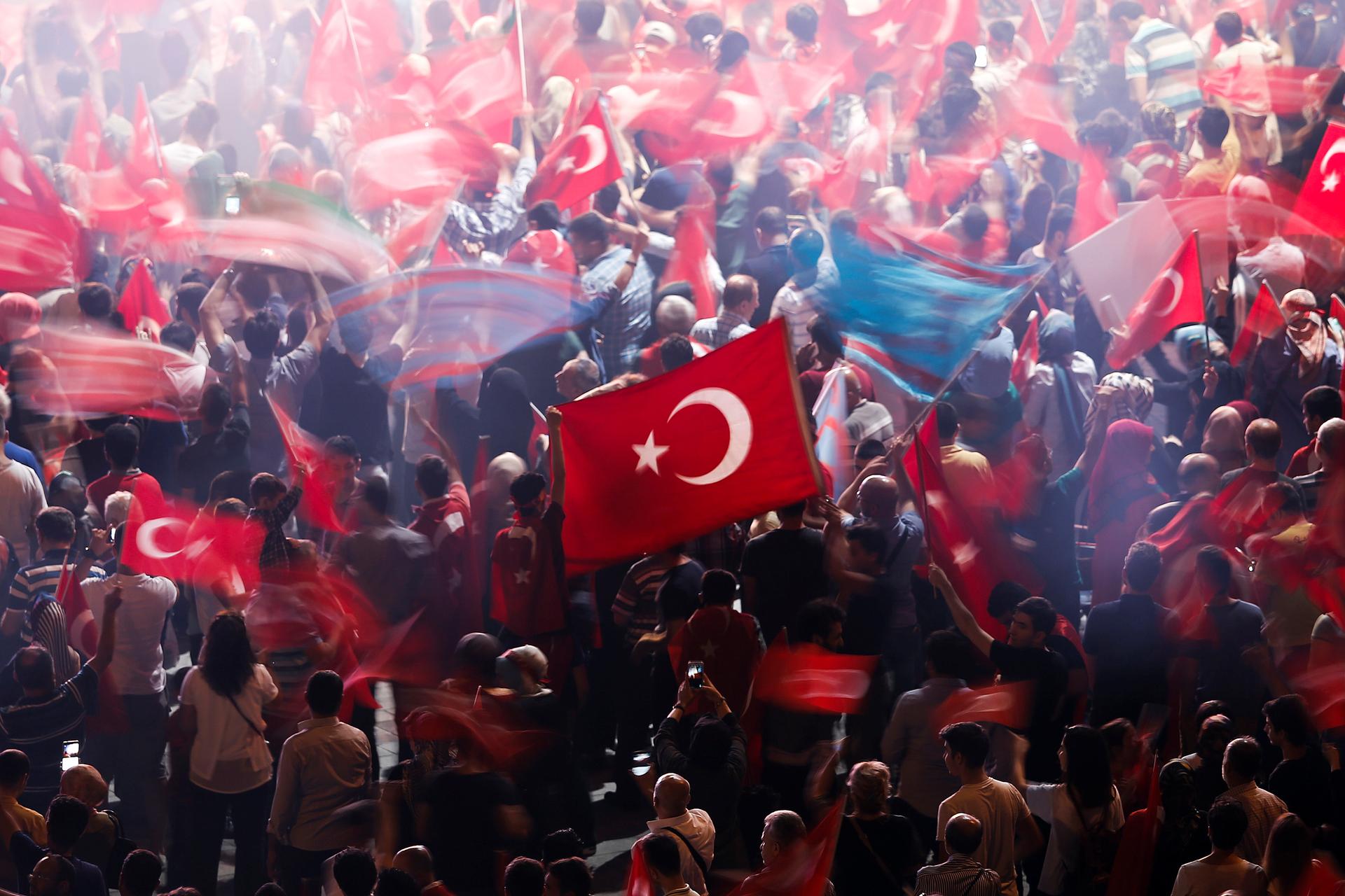 Supporters of Turkish President Tayyip Erdogan wave Turkish national flags during a pro-government demonstration on Taksim square in Istanbul, Turkey, July 19, 2016.