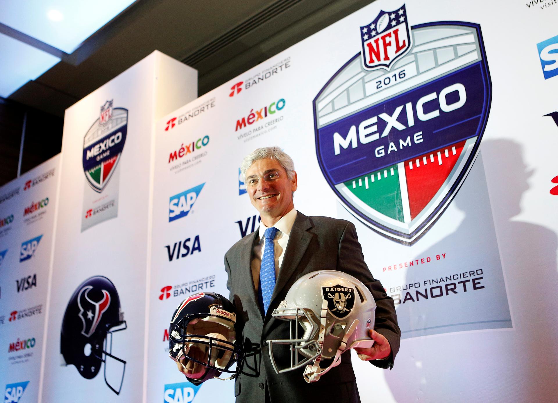 Representative of the National Football League (NFL) Arturo Oliver shows football helmets to the media to promote the regular season game between Houston Texans and Oakland Raiders, in Mexico City, Mexico July 19, 2016.