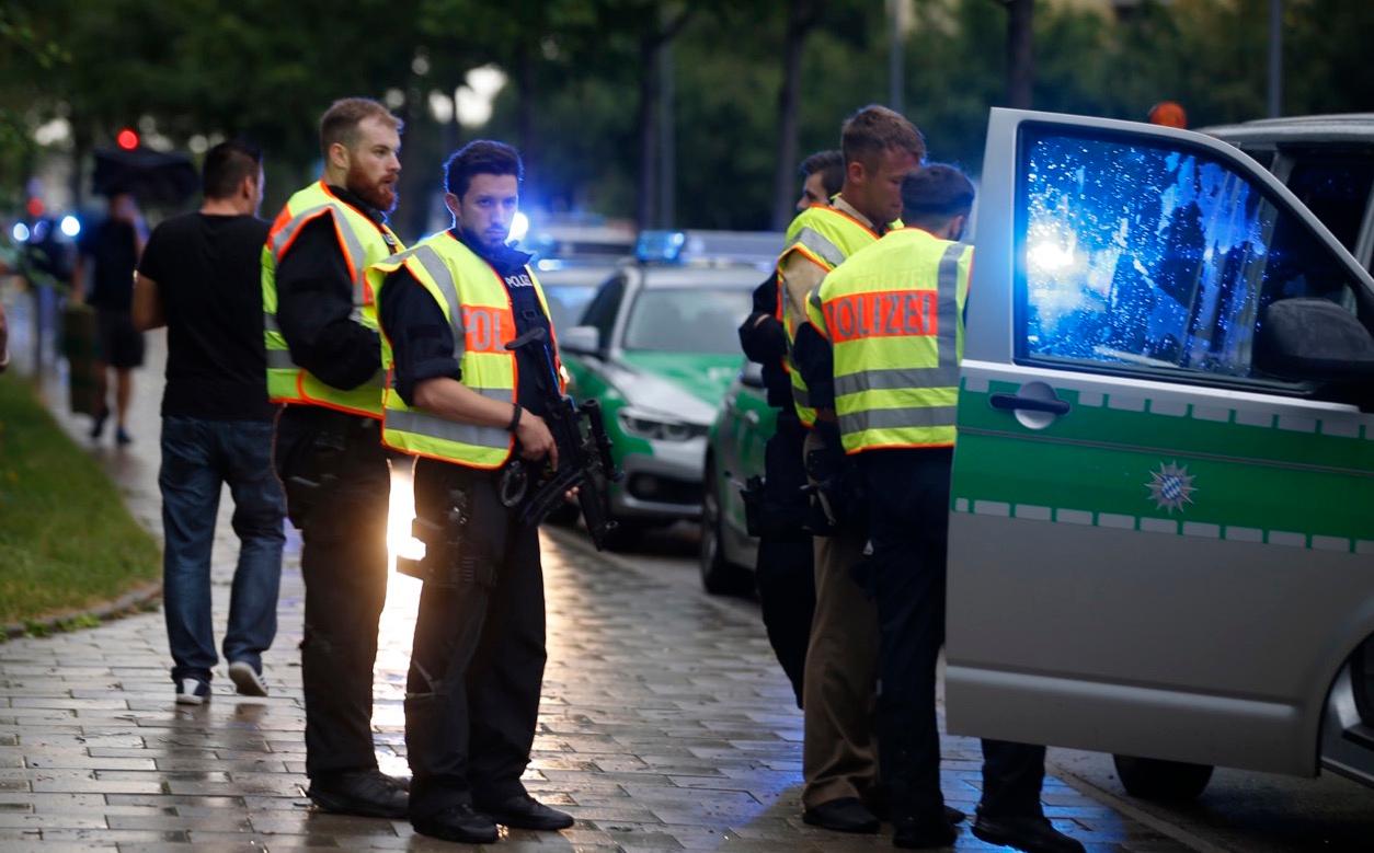 Police secure a street near to the scene of a shooting in Munich, Germany on Friday.