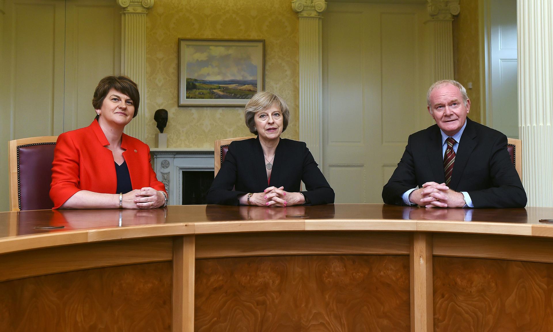 Northern Ireland first minister Arlene Foster (DUP), Britain's Prime Minister Theresa May (C), and deputy first minister Martin McGuinness at Stormont Castle in Belfast in 2016.