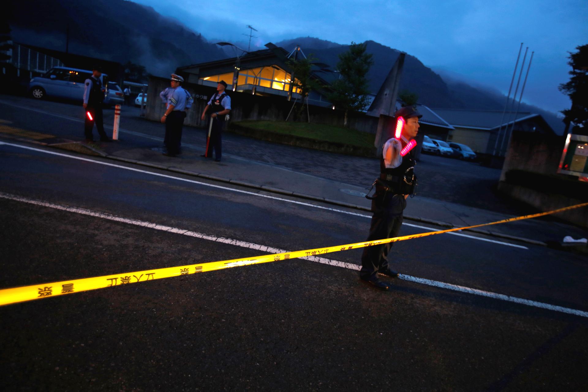 Police officers guard the front of a center for the disabled, where a mass knife killing took place, in Sagamihara, Kanagawa prefecture, Japan, on July 26.