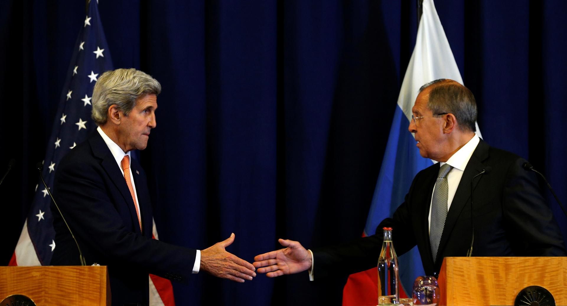 Secretary of State, John Kerry, and Russian Foreign Minister, Sergei Lavrov (R), shake hands after a meeting in Geneva, Switzerland, where they formulated a new ceasefire plan for Syria