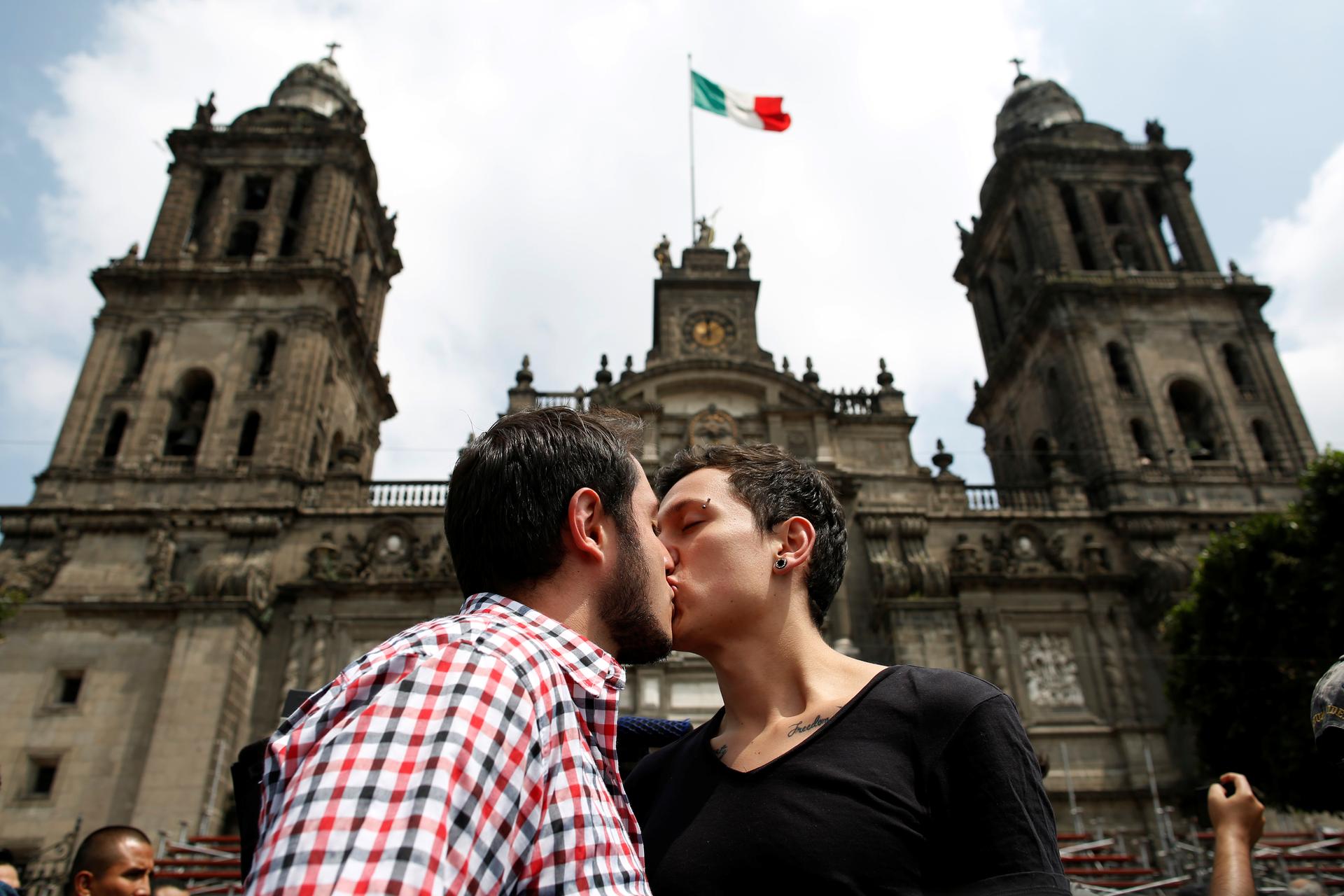 A couple kiss each other in front of the cathedral during a march in support of gay marriage, sexual and gender diversity in Mexico City, Mexico on September 11, 2016. There have been counter-demonstrations, against same-sex marriage, held in Mexican citi