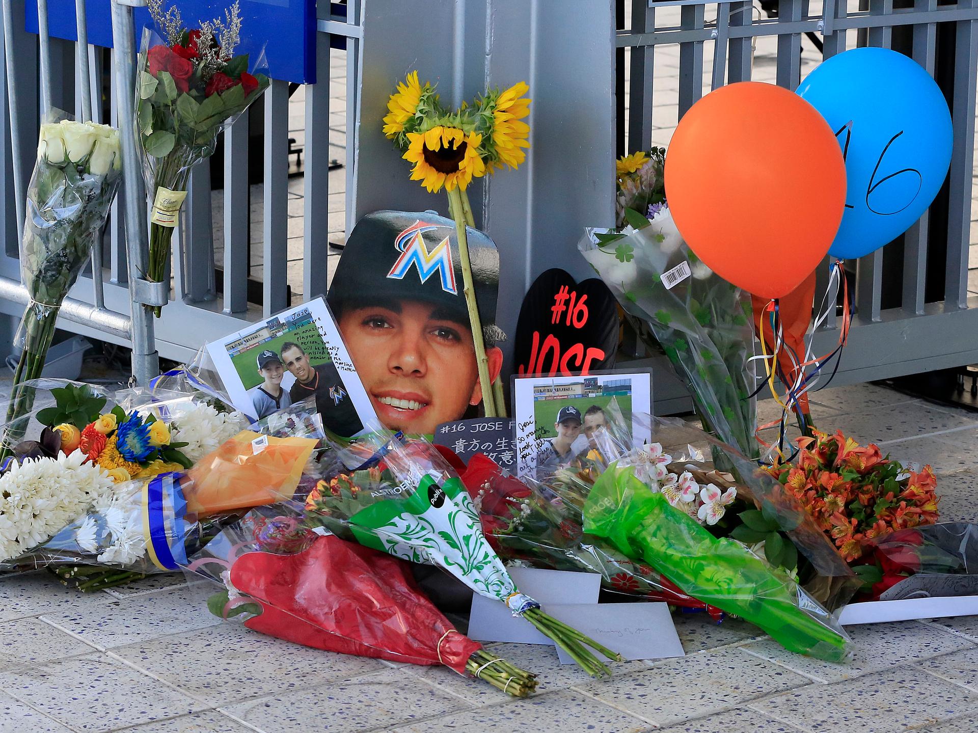 A memorial of flowers and photos are placed outside a gate at Marlins Park in honor of Miami Marlins starting pitcher Jose Fernandez who was killed in a boating accident.