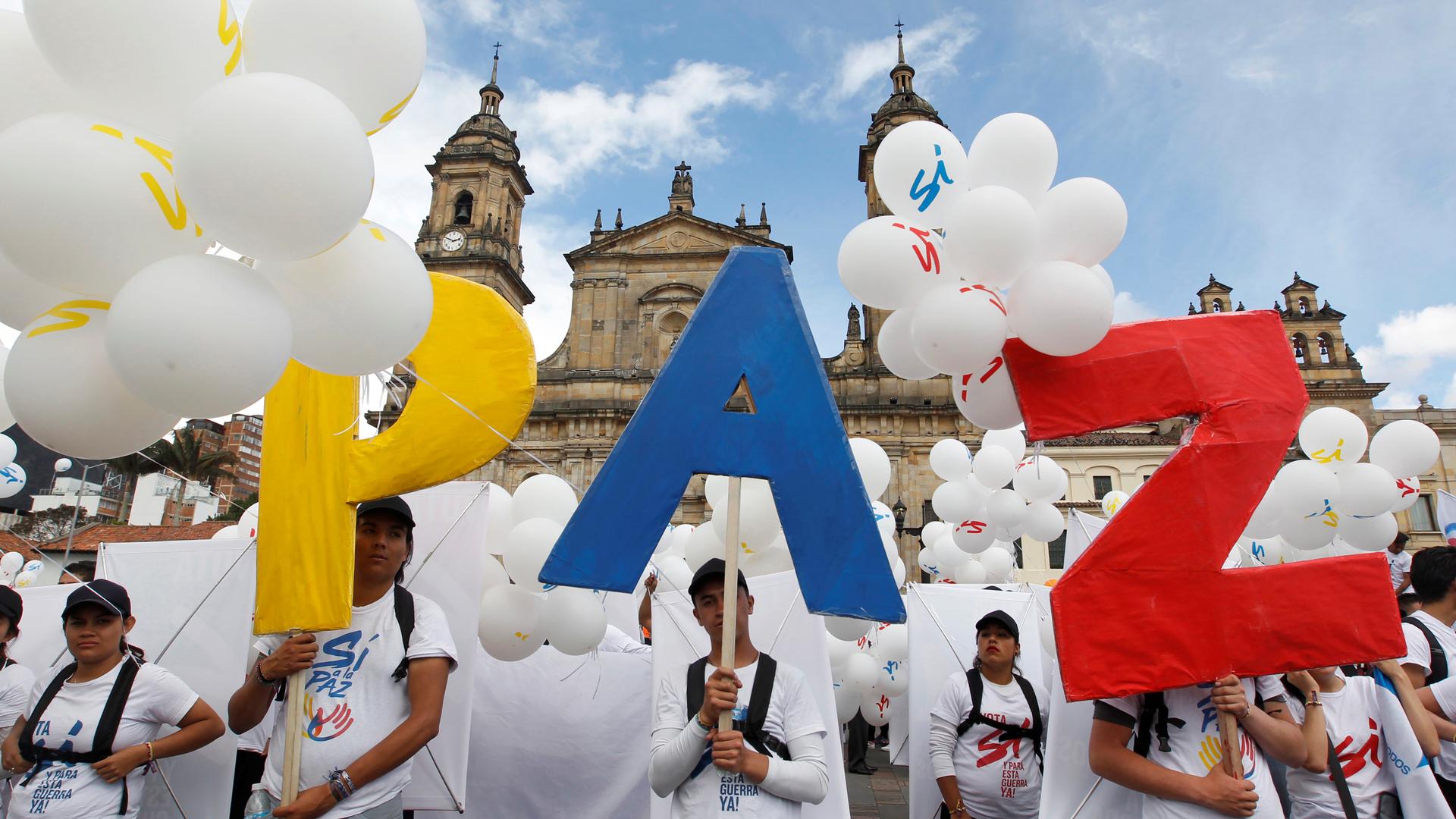 Colombians gather in Bogota’s Bolivar Square, to mark the signing of a historic peace deal with the FARC rebels.
