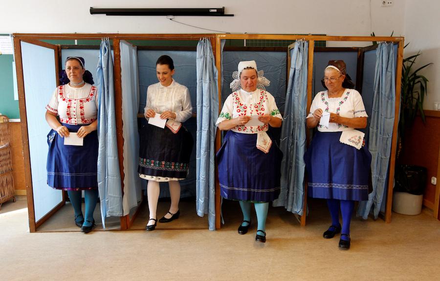 Hungarian women leave voting booths at a polling station during a referendum on European Union migrant quotas in Veresegyhaz, Hungary, on Oct. 2.