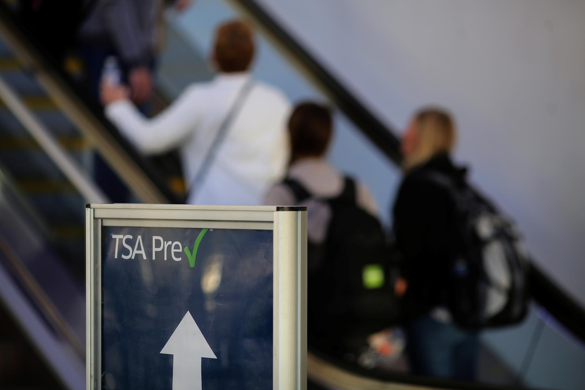 TSA Pre-check sign in front of escalator