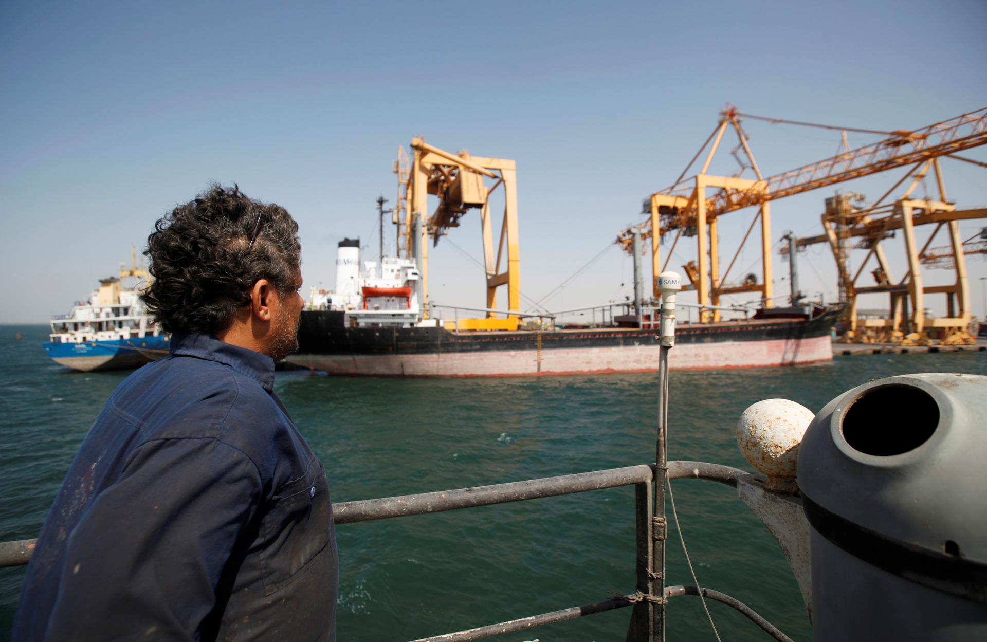 A Yemeni sailor looks at giant cranes, damaged by Saudi-led air strikes, at a container terminal at the Red Sea port of Hodeidah, Yemen