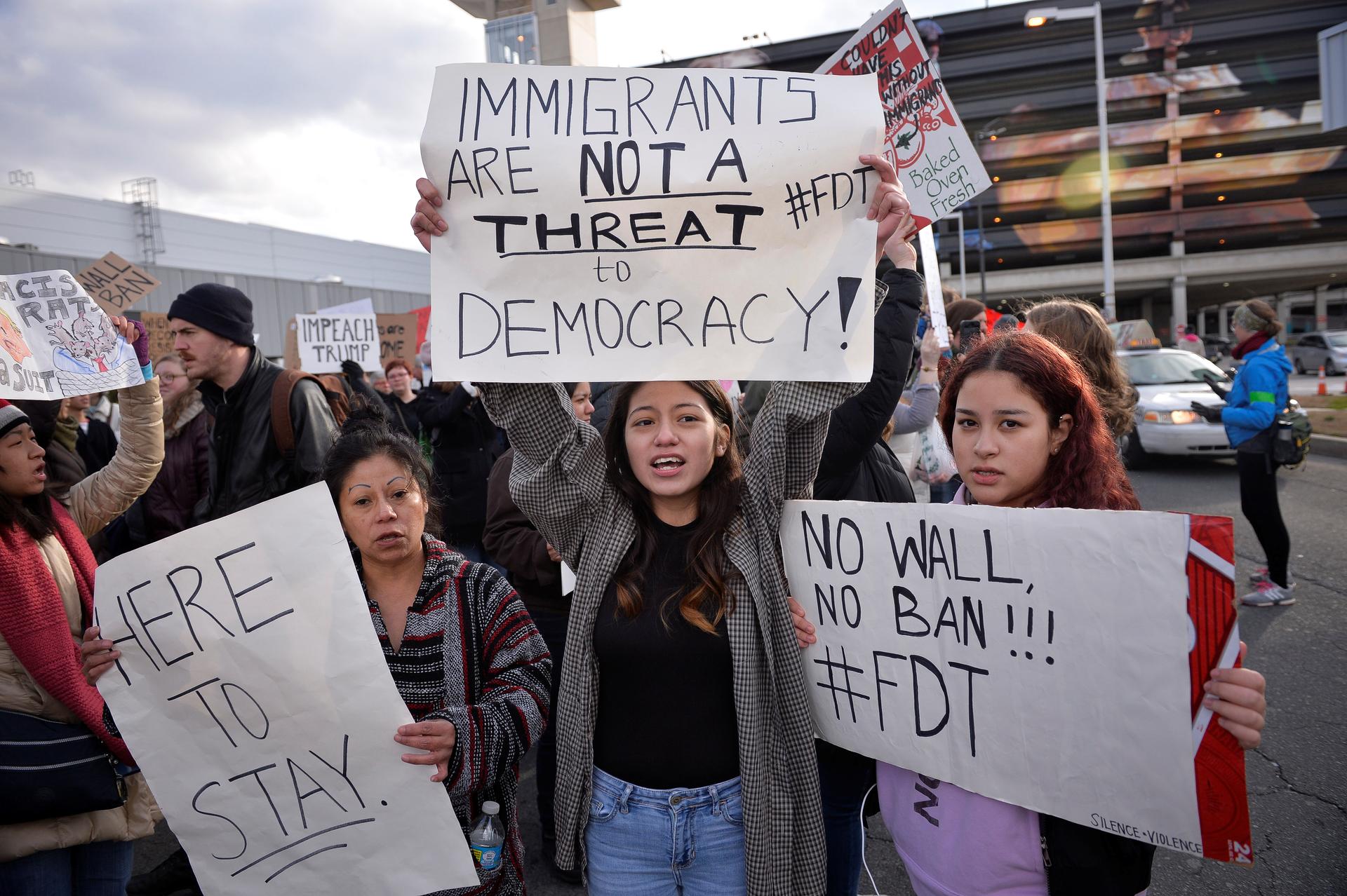 Demonstrators protest President Donald Trump's travel ban outside Philadelphia International Airport.