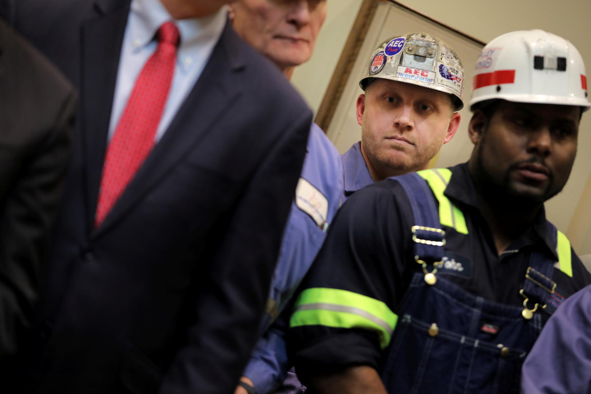 Two coal miners stand in the white house.