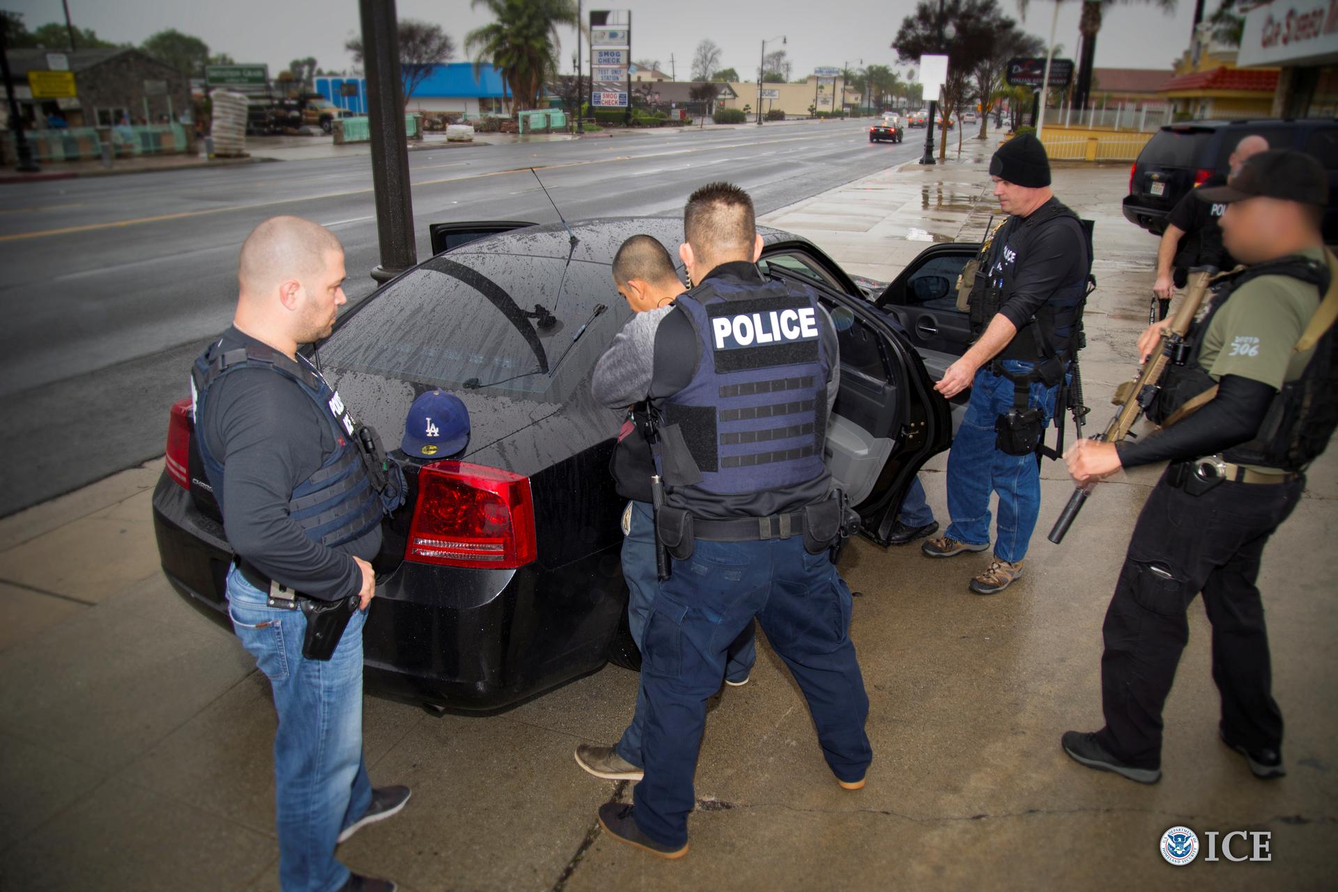 ICE officers detain a suspect as they conduct a targeted enforcement operation in Los Angeles.