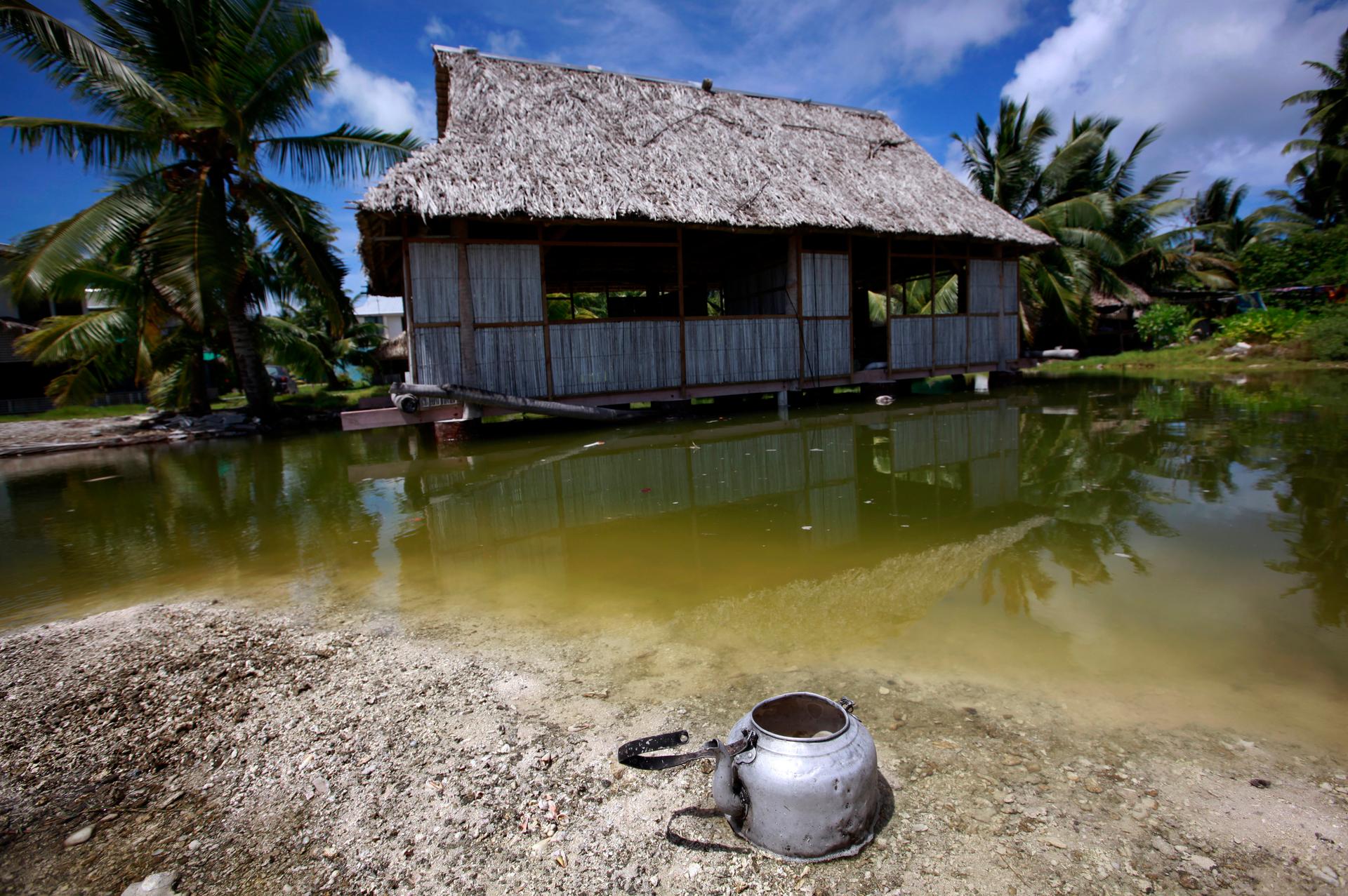 An abandoned house next to a small lagoon on South Tarawa in the central Pacific island nation of Kiribati in 2013. Nations like Kiribati and the Marshall Islands may disappear due to climate change.