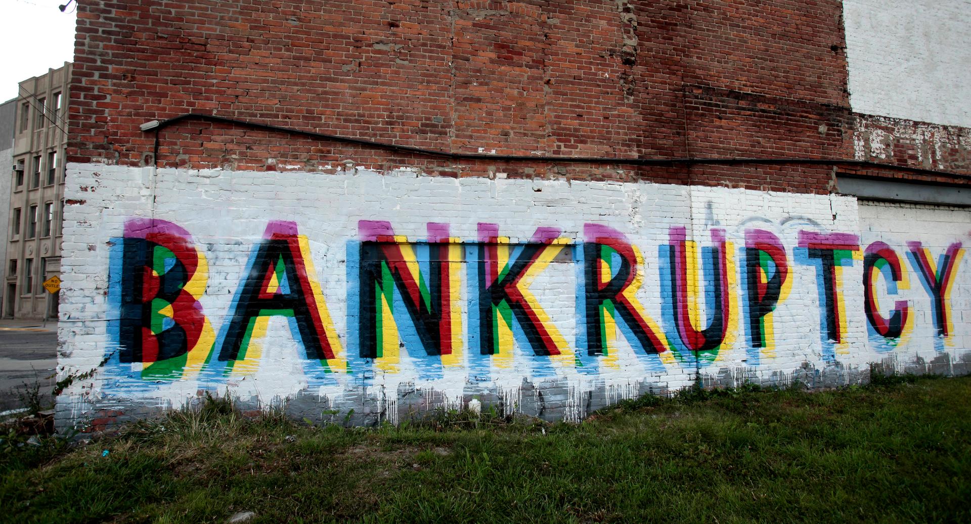 The word 'Bankruptcy' is seen painted on the side of a vacant building by street artists as a statement on the financial affairs of the city on Grand River Avenue in Detroit.