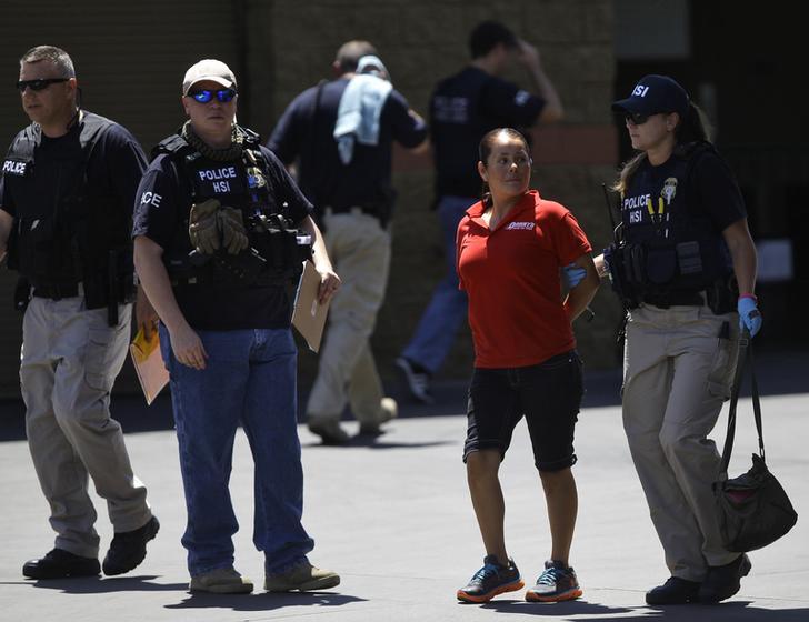 ICE agents detain a woman in Arizona in 2013