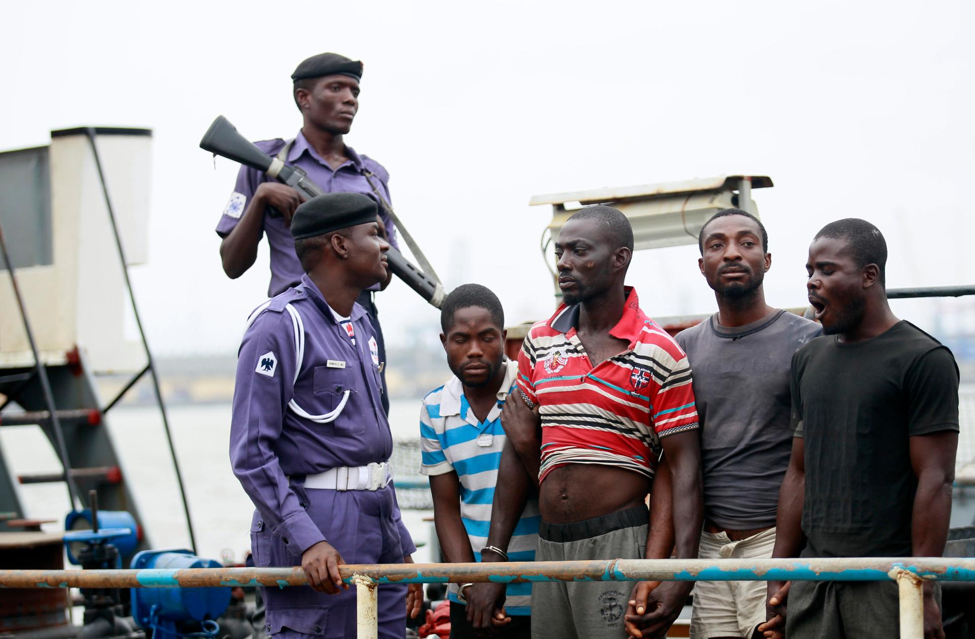 Suspected pirates are paraded aboard a ship at a Lagos naval base after their arrest by Nigerian authorities.