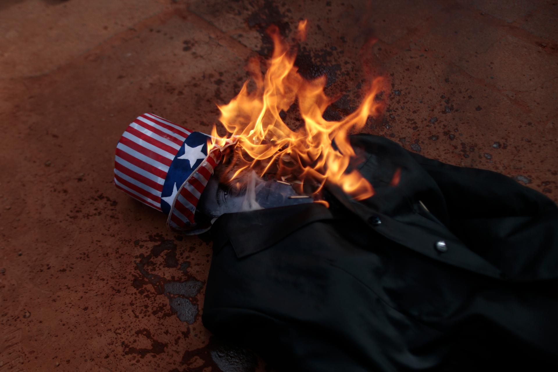 A burning effigy of President Barack Obama is seen during a protest by Brazilian students against possible US military action in Syria, in front of the US embassy in Brasilia last month.