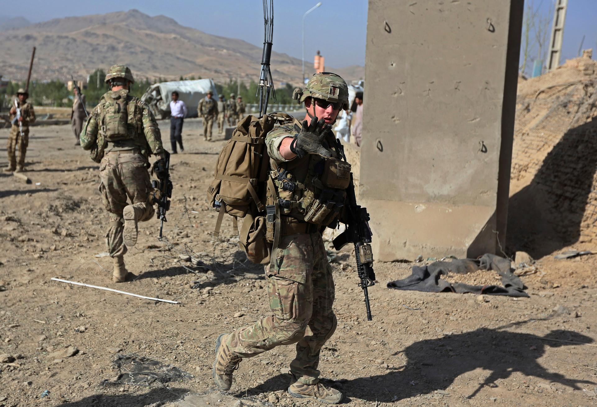 U.S. troops arrive at the site of a suicide attack in Maidan Shar, the capital of Wardak province in Afghanistan, on September 8, 2013. 