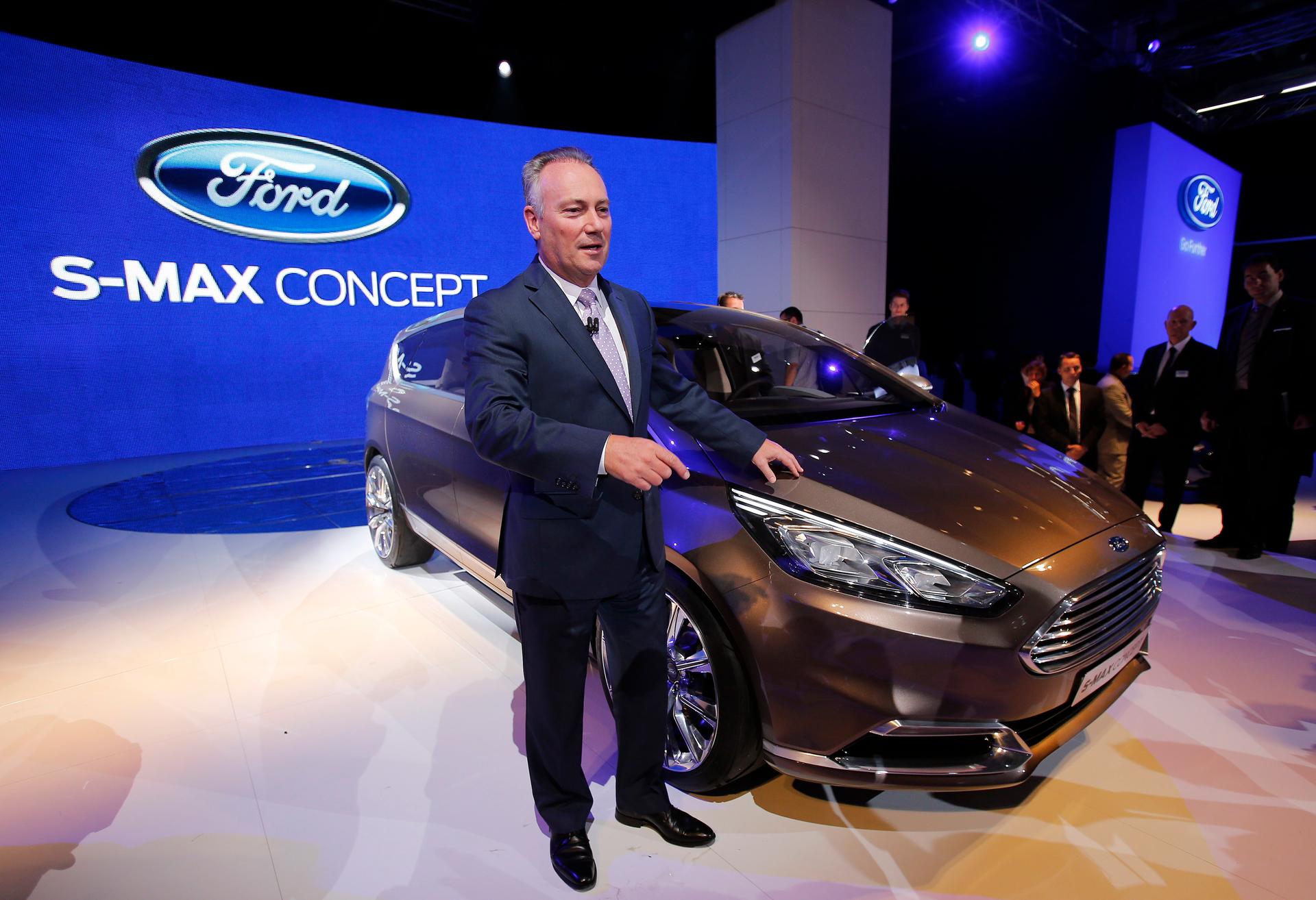 Ford of Europe CEO Steve Odell poses next to a Ford S-Max concept car during a media preview day at the 2013 Frankfurt Motor Show.