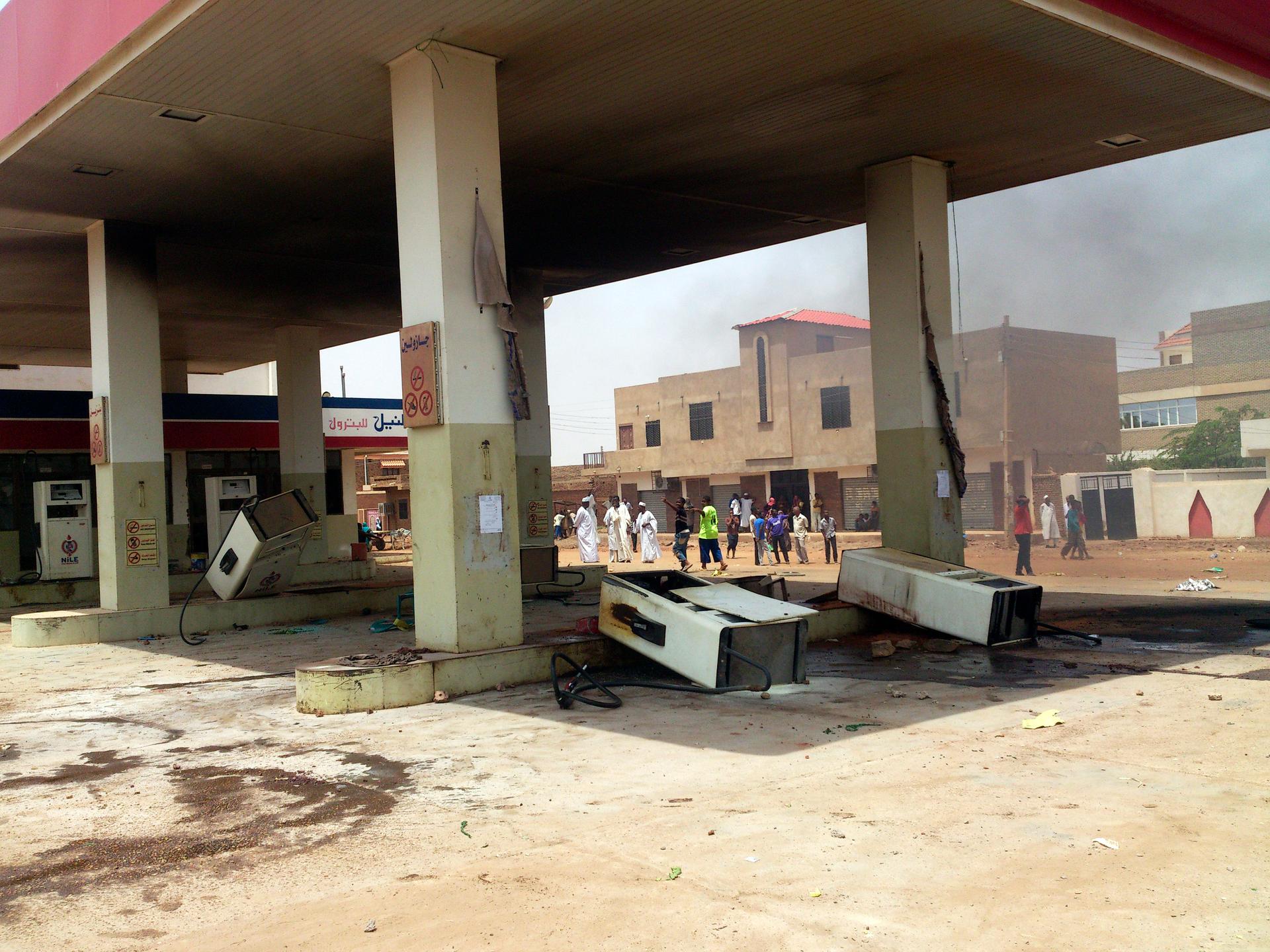 Gas station fuel pumps are toppled during protests over fuel subsidy cuts in Khartoum September 25, 2013