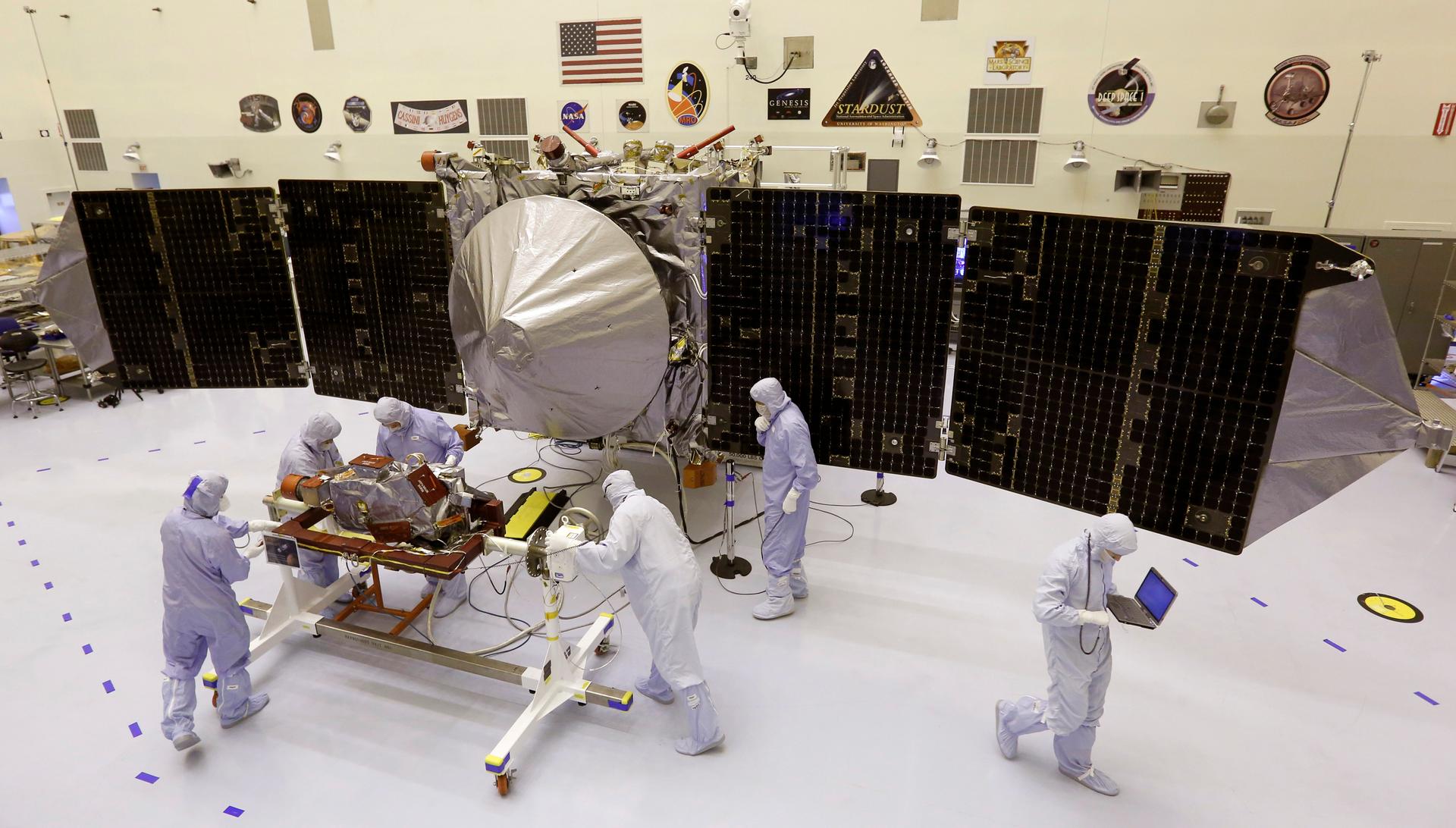 NASA technicians work on a Mars-bound spacecraft. Unmanned missions to Mars have mostly been successful, but the effort to sent a human being there is proving a harder task — and a harder sell.
