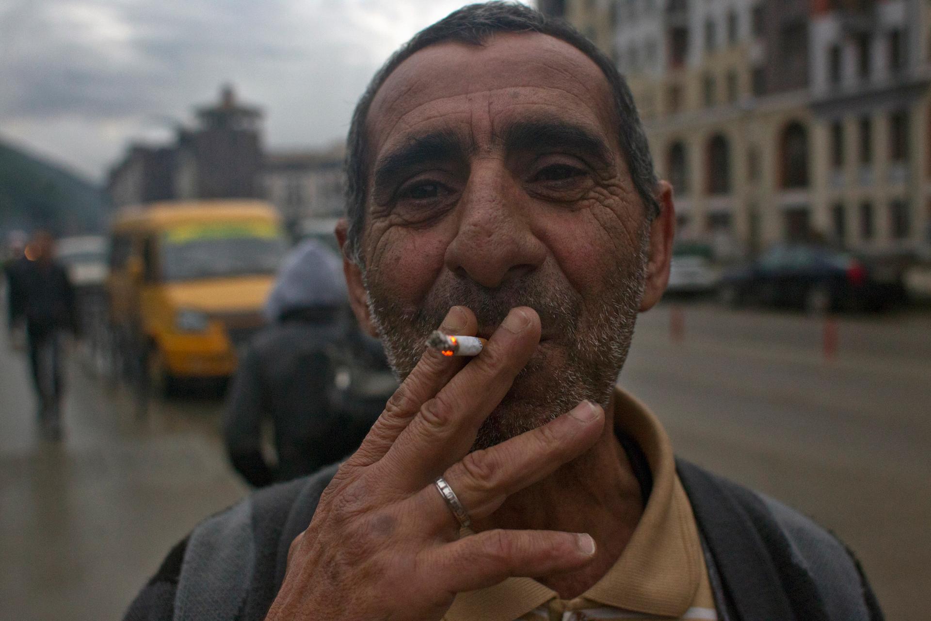 A migrant worker smokes in the village of Krasnaya Polyana, a venue for the Sochi 2014 winter Olympics, some 40 kilometres (25 miles) east from Sochi September 21, 2013. 