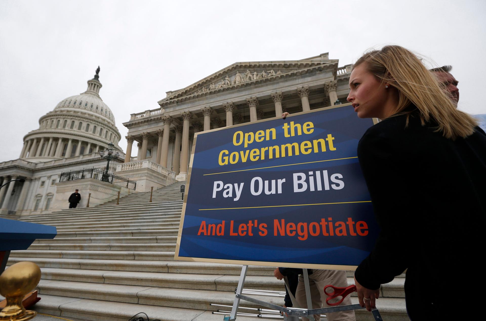 A US senate staffer places a sign at the steps of the US Capitol in Washington,
