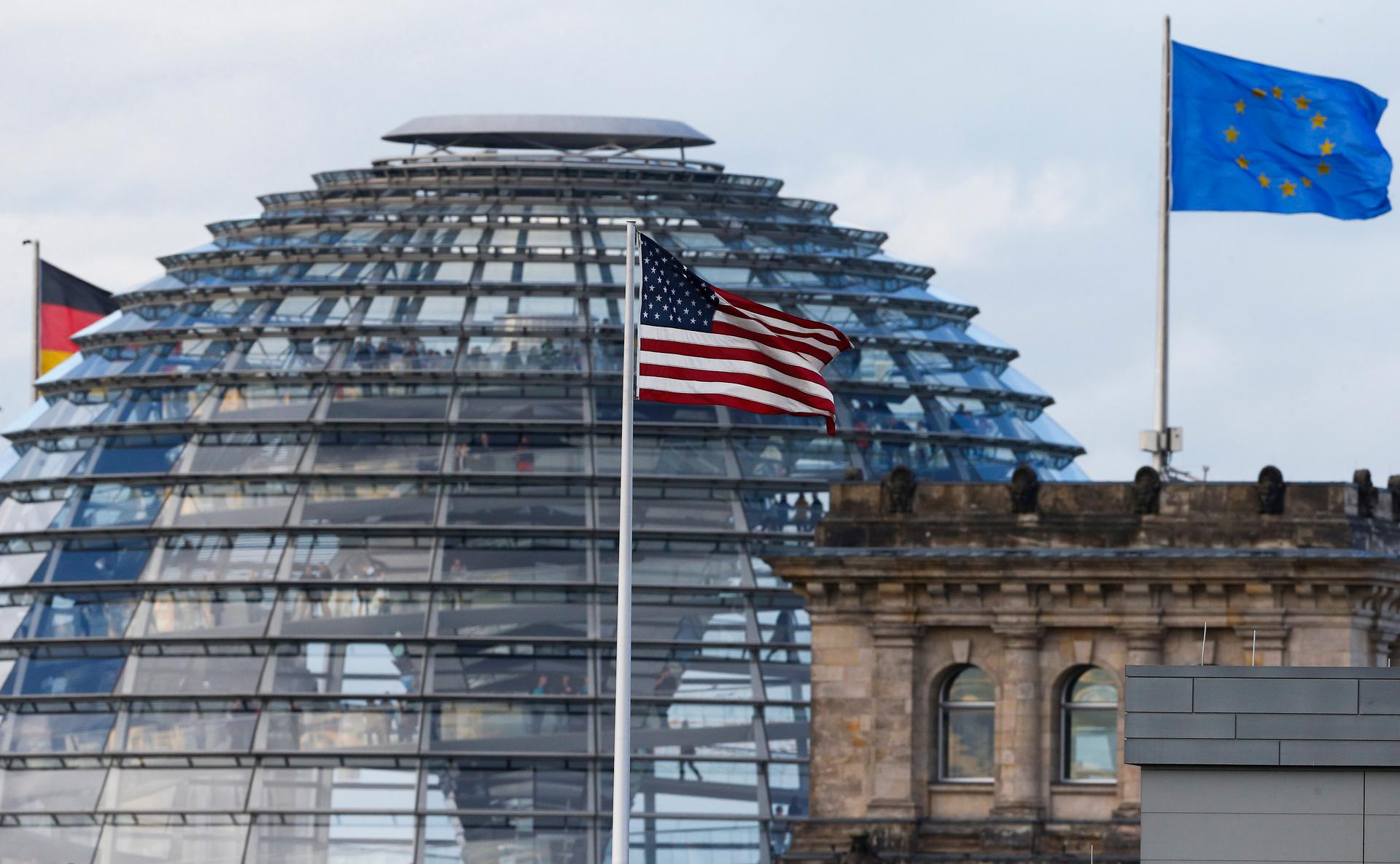 The flag on the US embassy is pictured next to the Reichstag building, seat of the German lower house of parliament Bundestag. A German newspaper said on Sunday that President Barack Obama knew his intelligence service was eavesdropping on Angela Merkel a