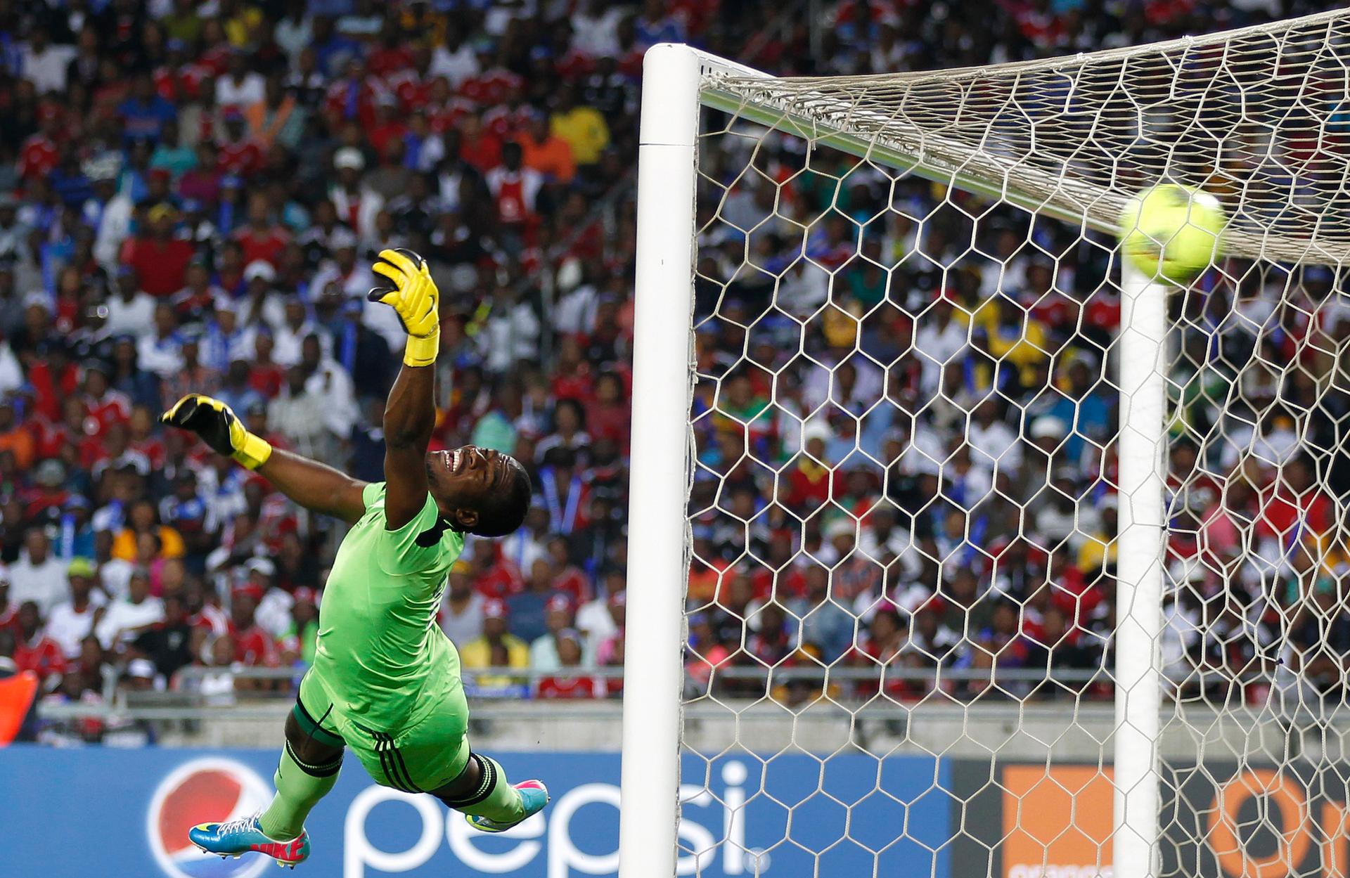 Goalkeeper Senzo Meyiwa of South Africa's Orlando Pirates is beaten by a shot from Mohamed Aboutrika of Egypt's Al Ahli at Orlando Stadium in Soweto on November 2, 2013.