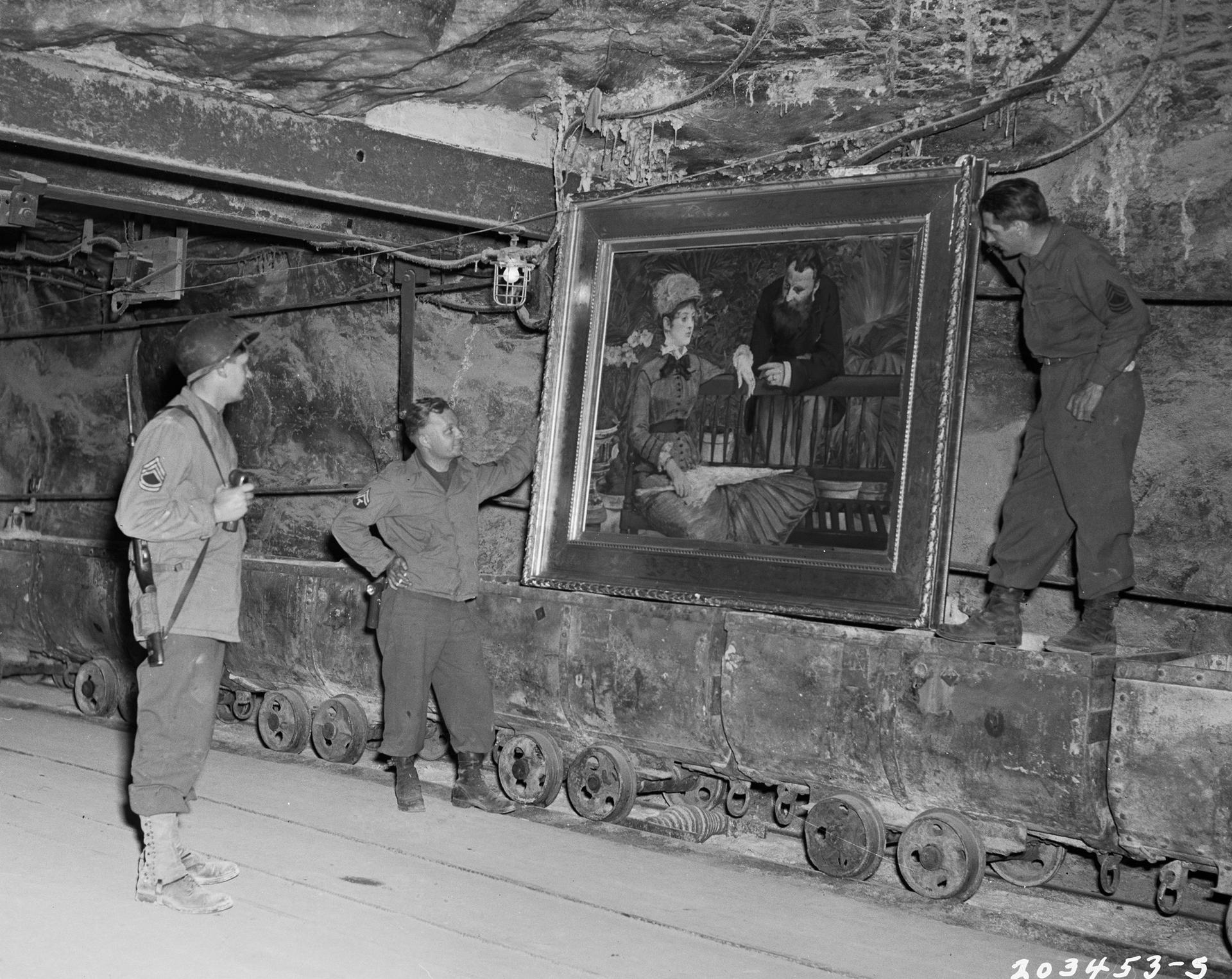 U.S. soldiers examine the painting, "Wintergarden," by French Impressionist painter Edouard Manet, stolen by the Nazi regime and hidden in a salt mine in Merkers, Germany April 15, 1945. 