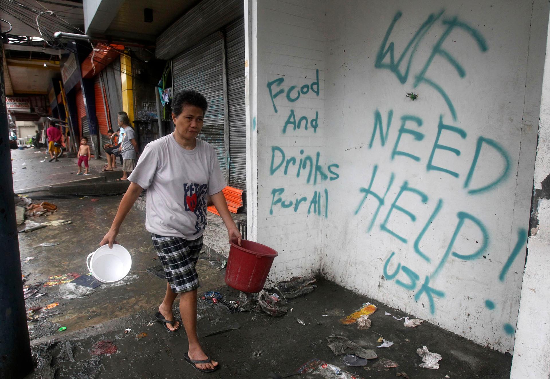 Graffiti calling for help after Typhoon Haiyan devastated Tacloban city, in the central Philippines.
