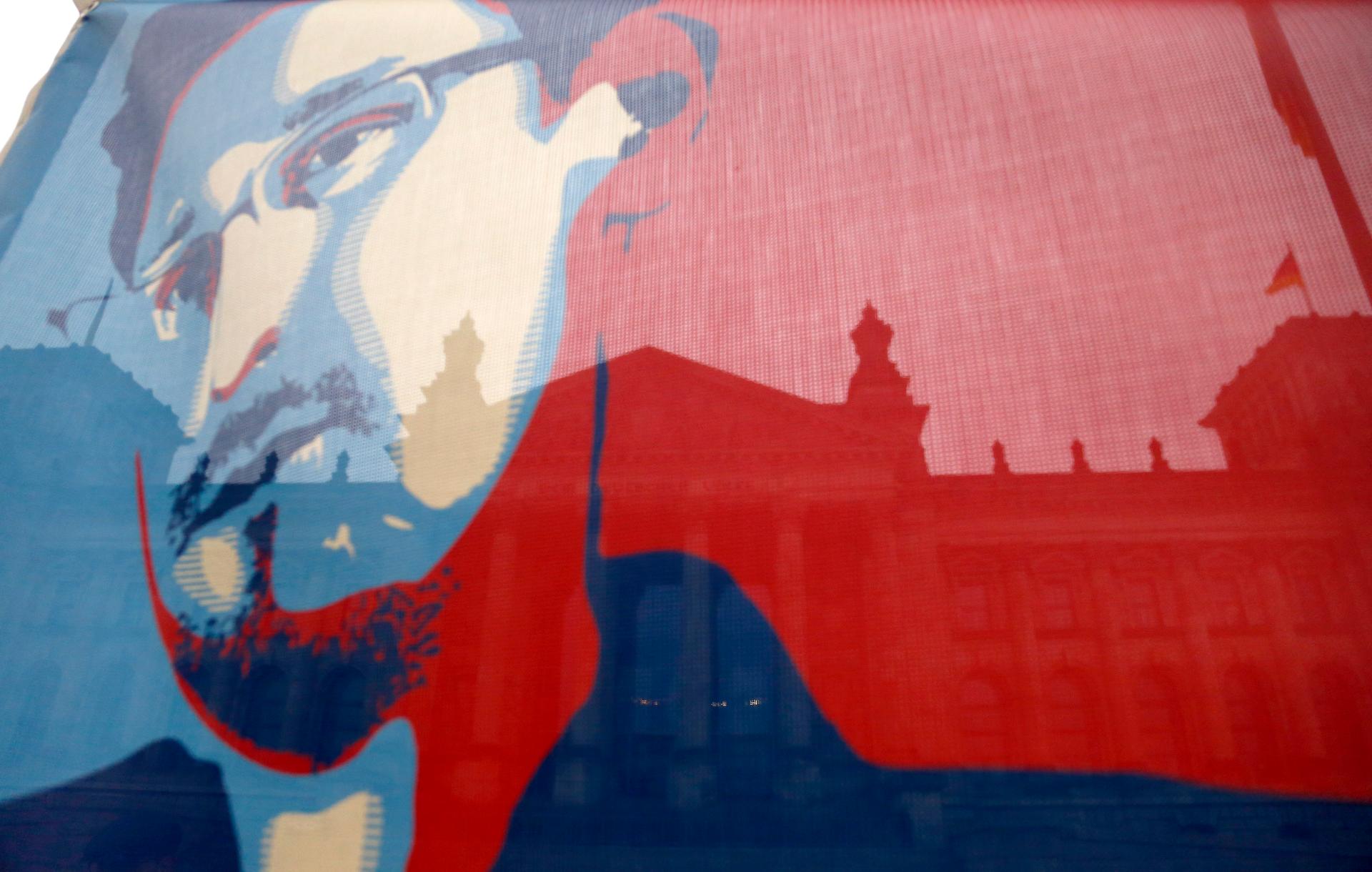 Germany's Reichstag building pictured though a flag depicting former NSA contractor Edward Snowden.
