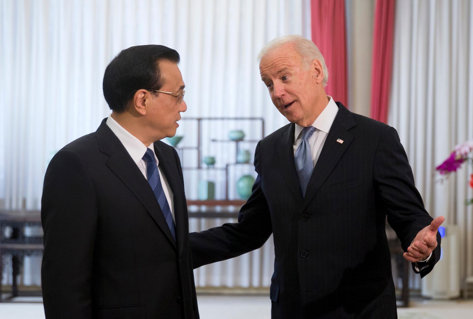 U.S. Vice President Joe Biden chats with Chinese Premier Li Keqiang in Beijing on December 5, 2013. Biden raised the issue of press freedom with China.  