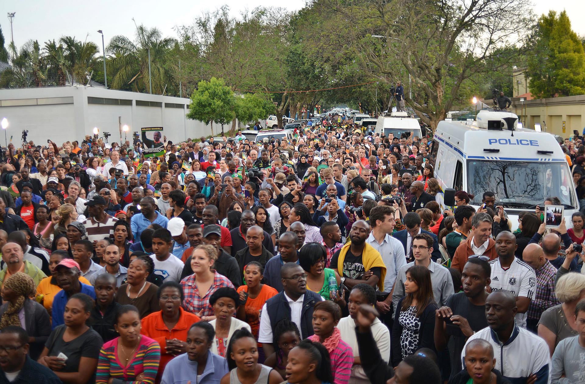 People gathered at Nelson Mandela's home outside of Johannesburg on December 6, 2013.