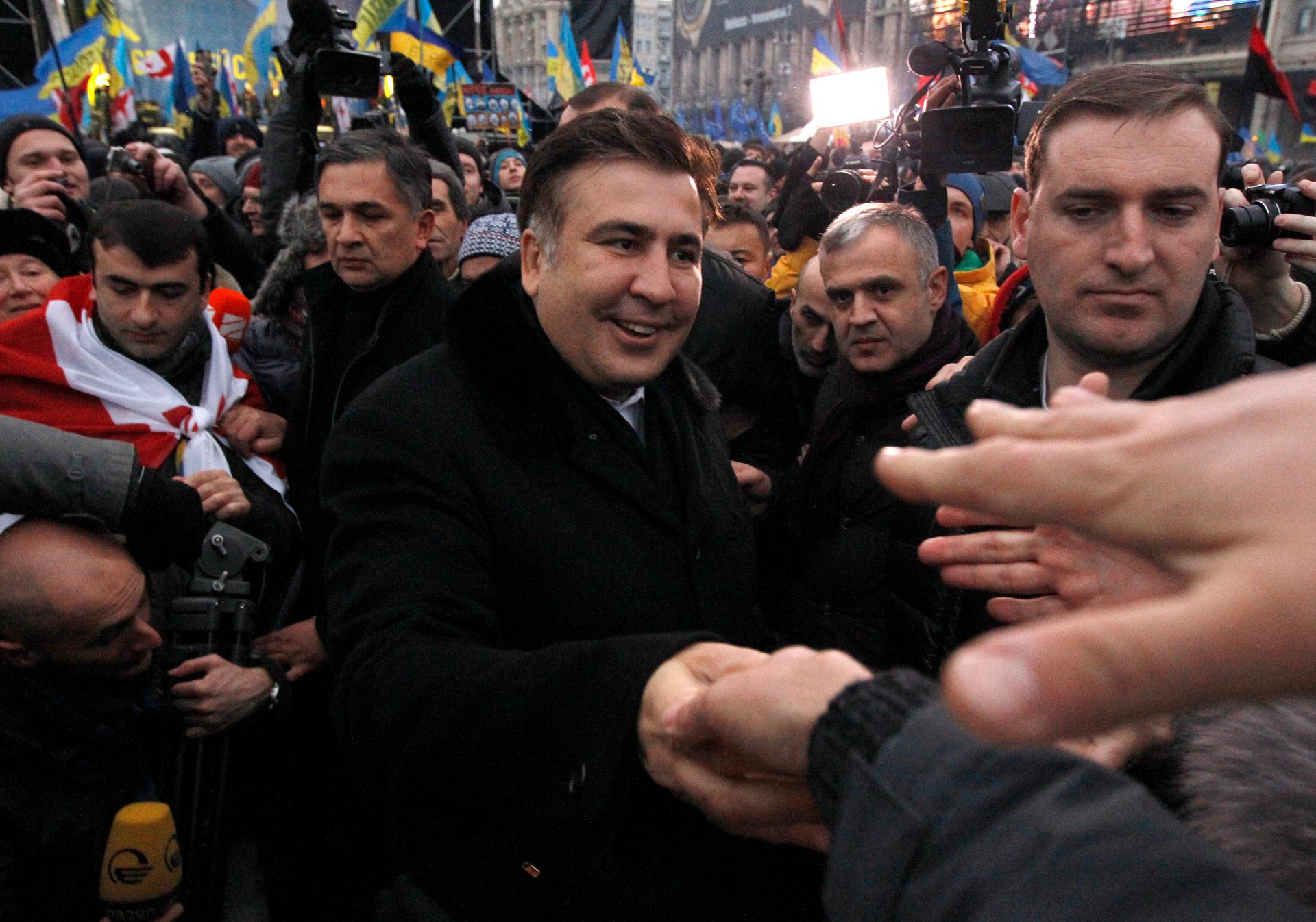 Former Georgian President Mikheil Saakashvili meets pro-European integration protestors in Independence square in Kiev, December 7, 2013. 