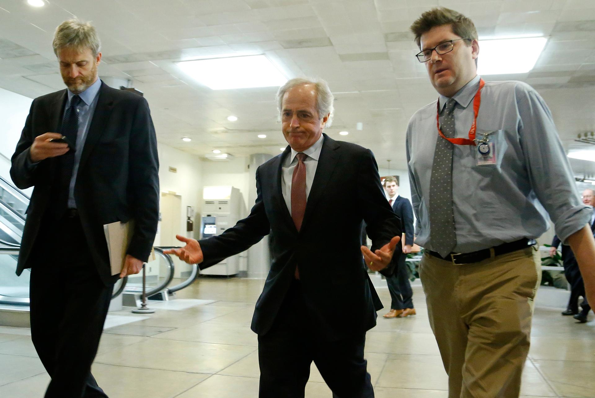 Senator Bob Corker (R-Tenn.) shrugs at a question from reporters as he walks to a closed-door briefing on talks with Iran in 2013. Corker is a leading proponent of raising gas taxes to boost the nearly-dry Highway Trust Fund.