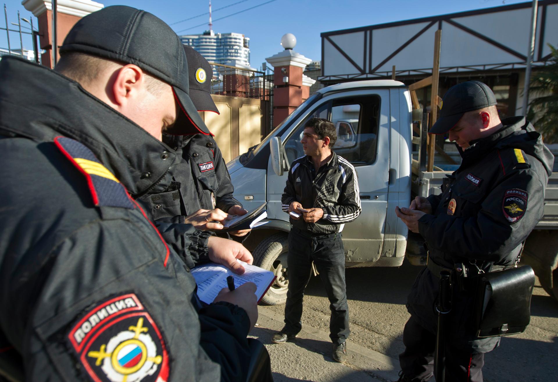 Russian police check a driver's documents in Sochi December 30, 2013. The International Olympic Committee has no doubt Russian authorities will be able to provide security at the Winter Olympics, a spokeswoman said on Monday after two bomb blasts killed t
