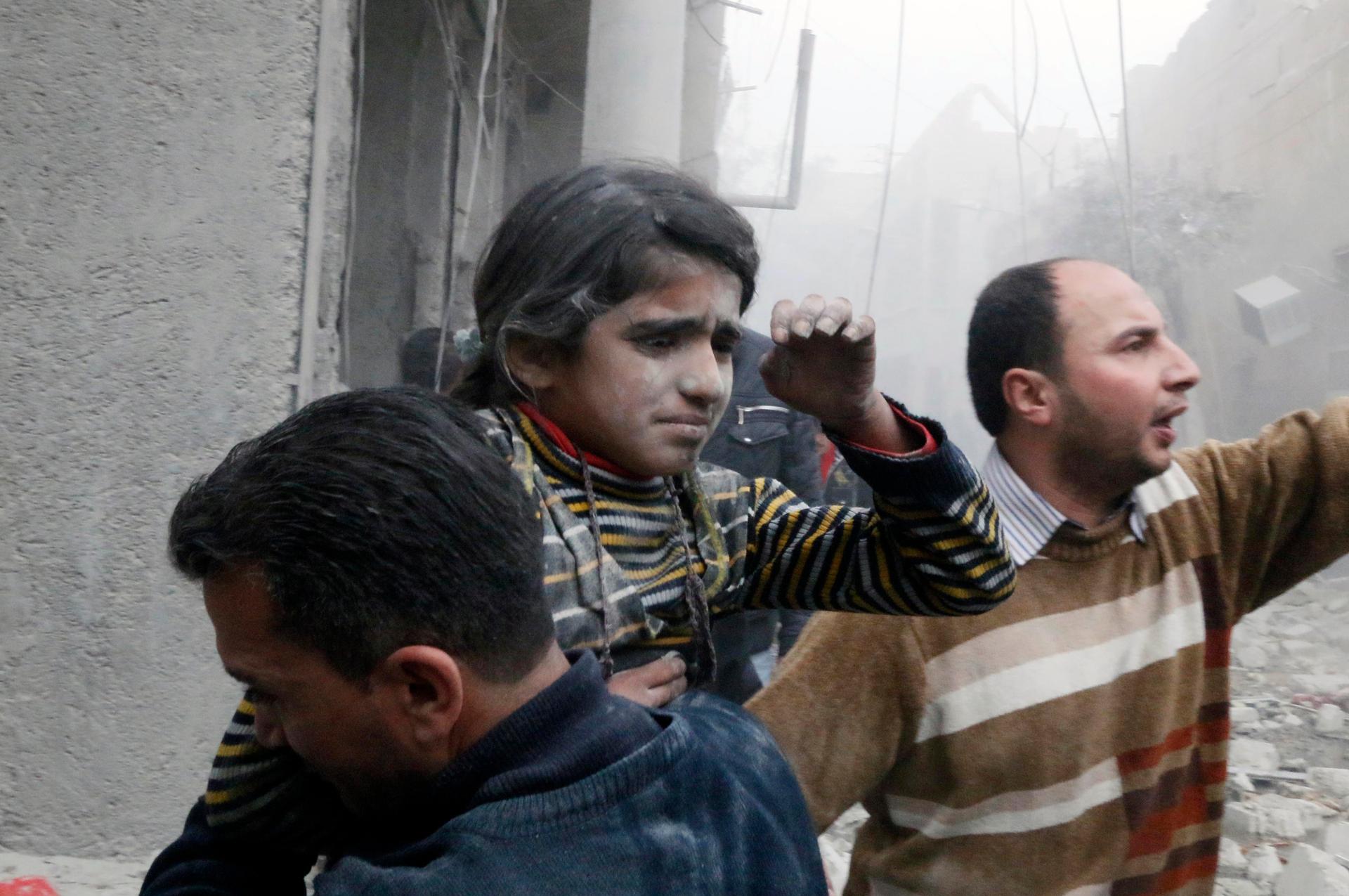 A Syrian girl is rescued from a damaged building after both of her parents died in what activists said was a government air strike.