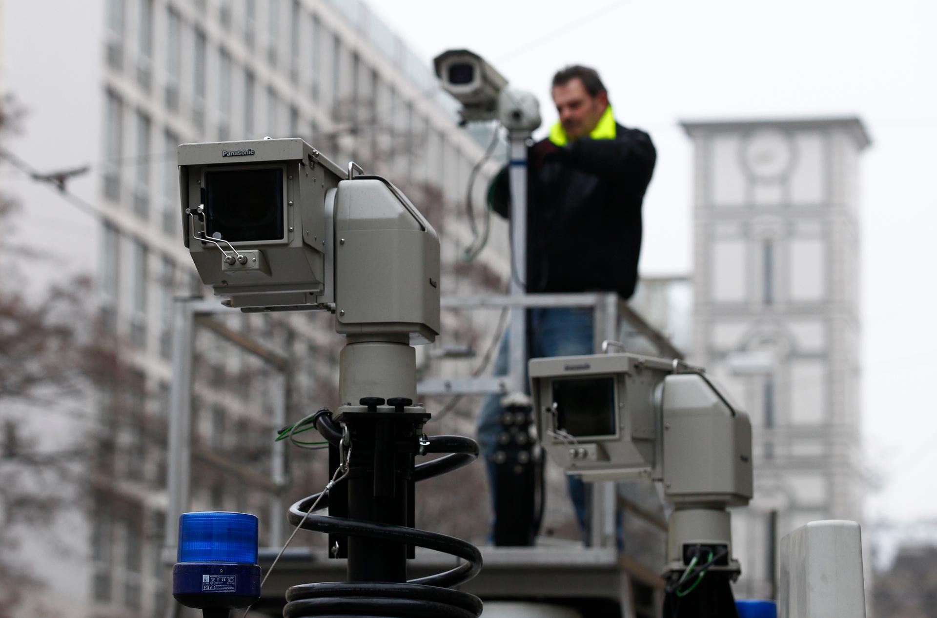 A man assembles police observation cameras near the Bayerischer Hof hotel before the start of the 50th Conference on Security Policy in Munich on January 31, 2014