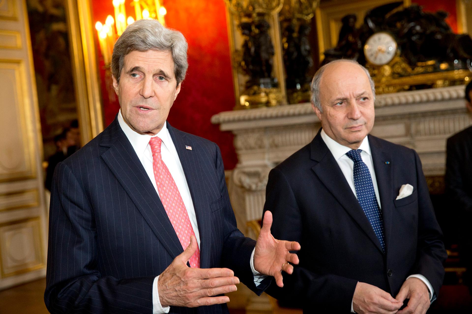 U.S. Secretary of State John Kerry (left) gestures during a statement on the violence in Ukraine before a meeting with French Foreign Minister Laurent Fabius in Paris February 19, 2014.