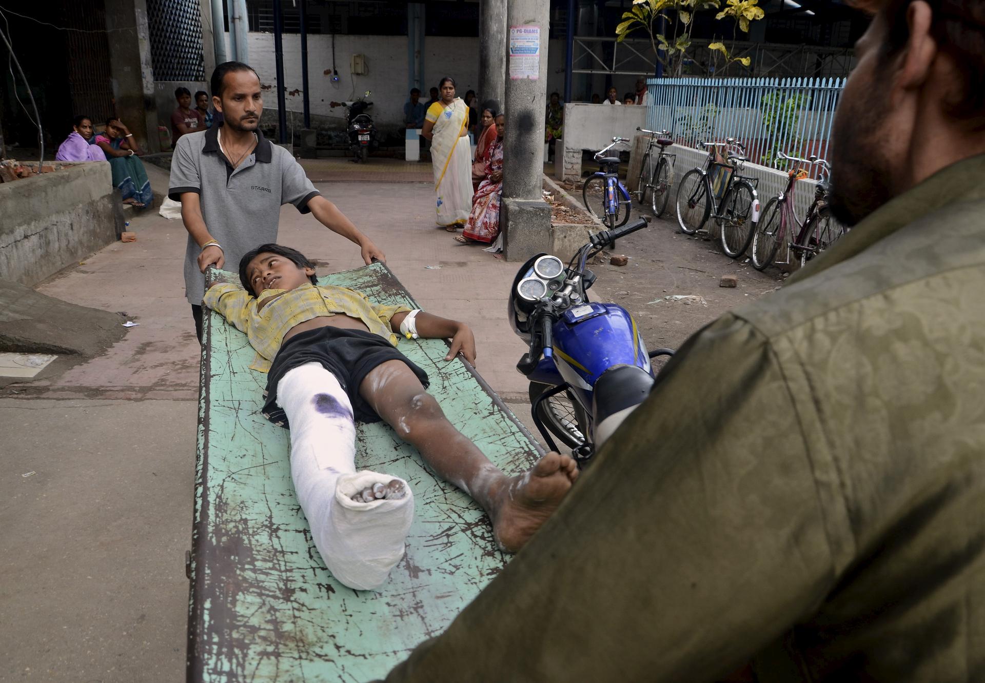 An injured boy is taken to a ward inside a hospital after an earthquake in Siliguri
