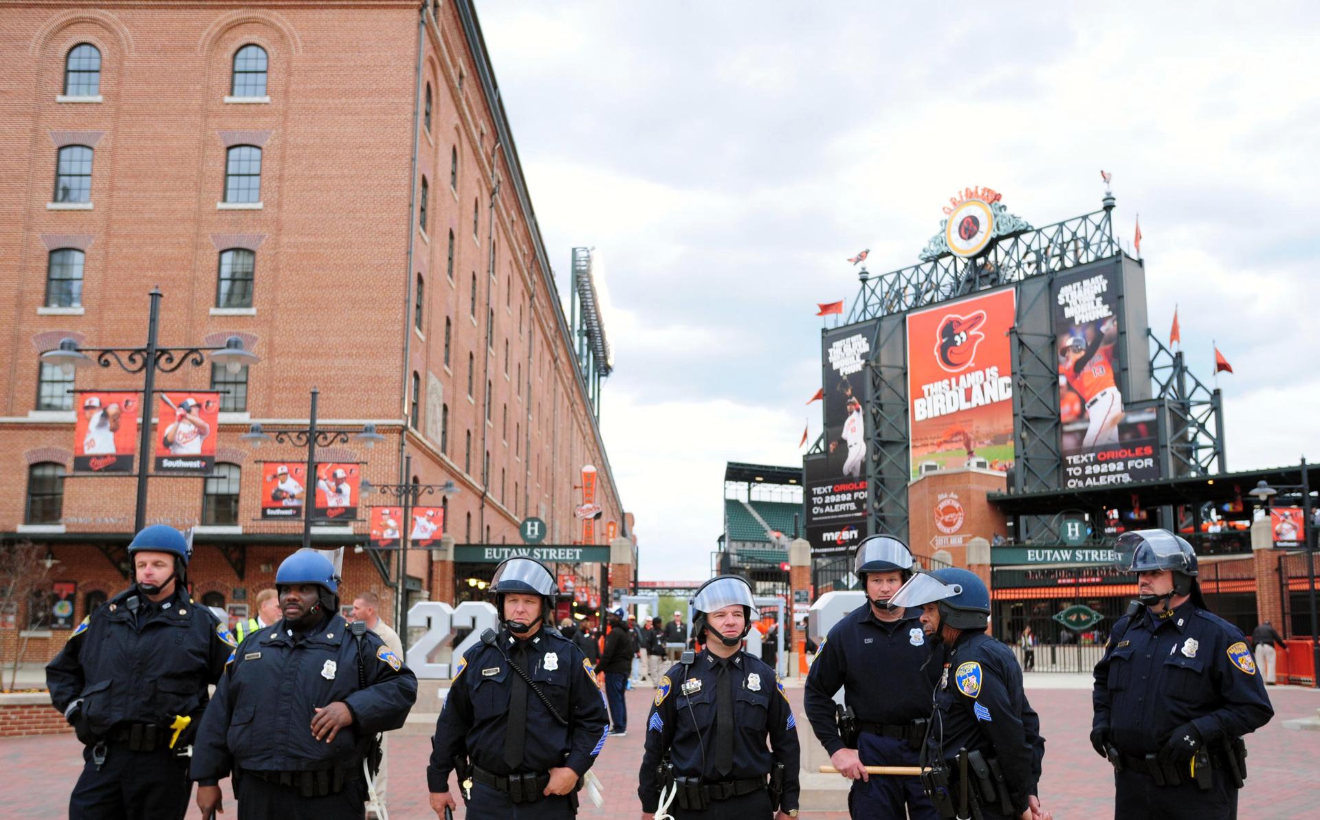 Baltimore police officers stand outside of Oriole Park at Camden Yards prior to the cancellation of a game between the Chicago White Sox and Baltimore Orioles on April 27, 2015.