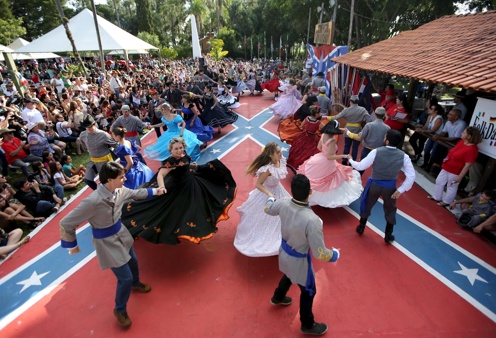 Descendants of American Southerners wearing Confederate-era dresses and uniforms dance during a party to celebrate the 150th anniversary of the end of the American Civil War in Santa Barbara D'Oeste, Brazil, April 26, 2015.